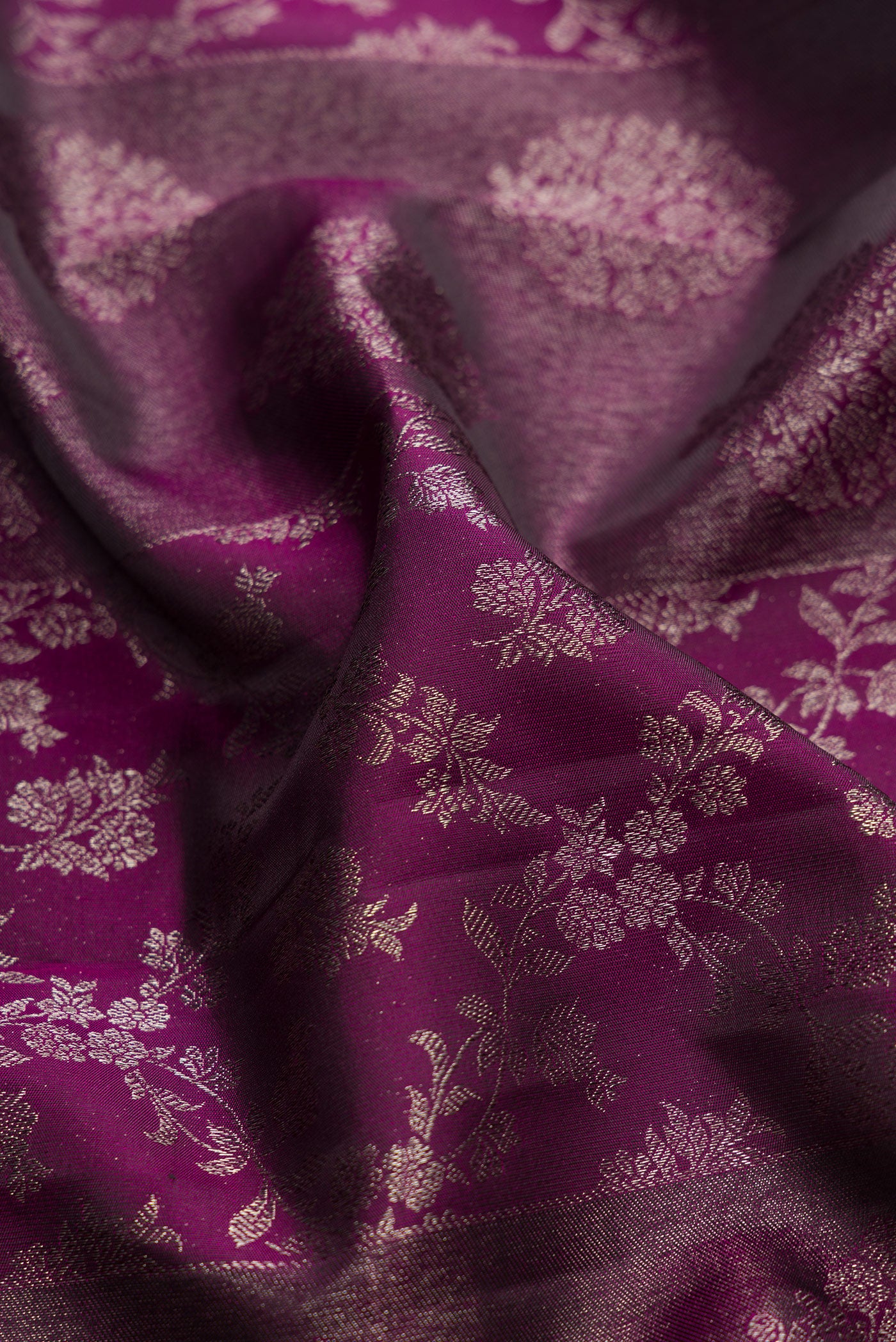 Close up of Burgundy Dual Tone Kanjivaram Silk Saree with Zari Brocade on the body and Zari Border.  displaying folds