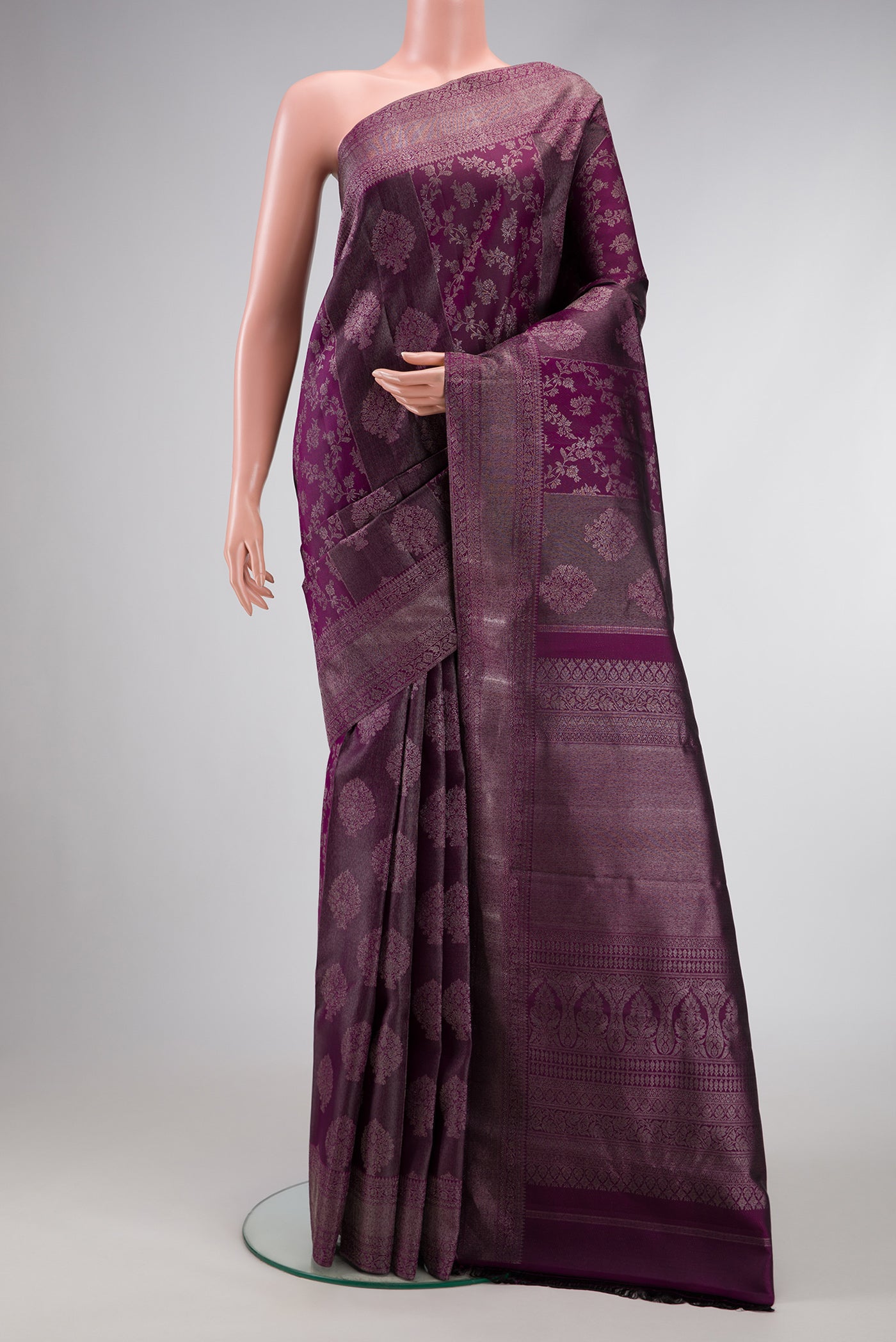 Burgundy Dual Tone Kanjivaram Silk Saree with Zari Brocade on the body and Zari Border.  displayed on a mannequin