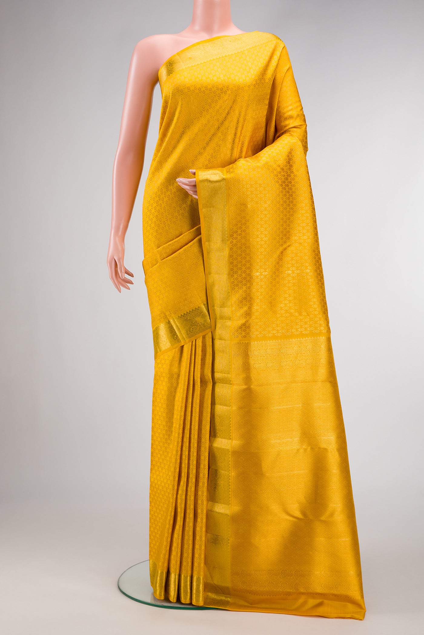 Yellow Dual Tone Kanchipuram Silk Saree with Zari Brocade on the body and Zari Border.  displayed on a mannequin