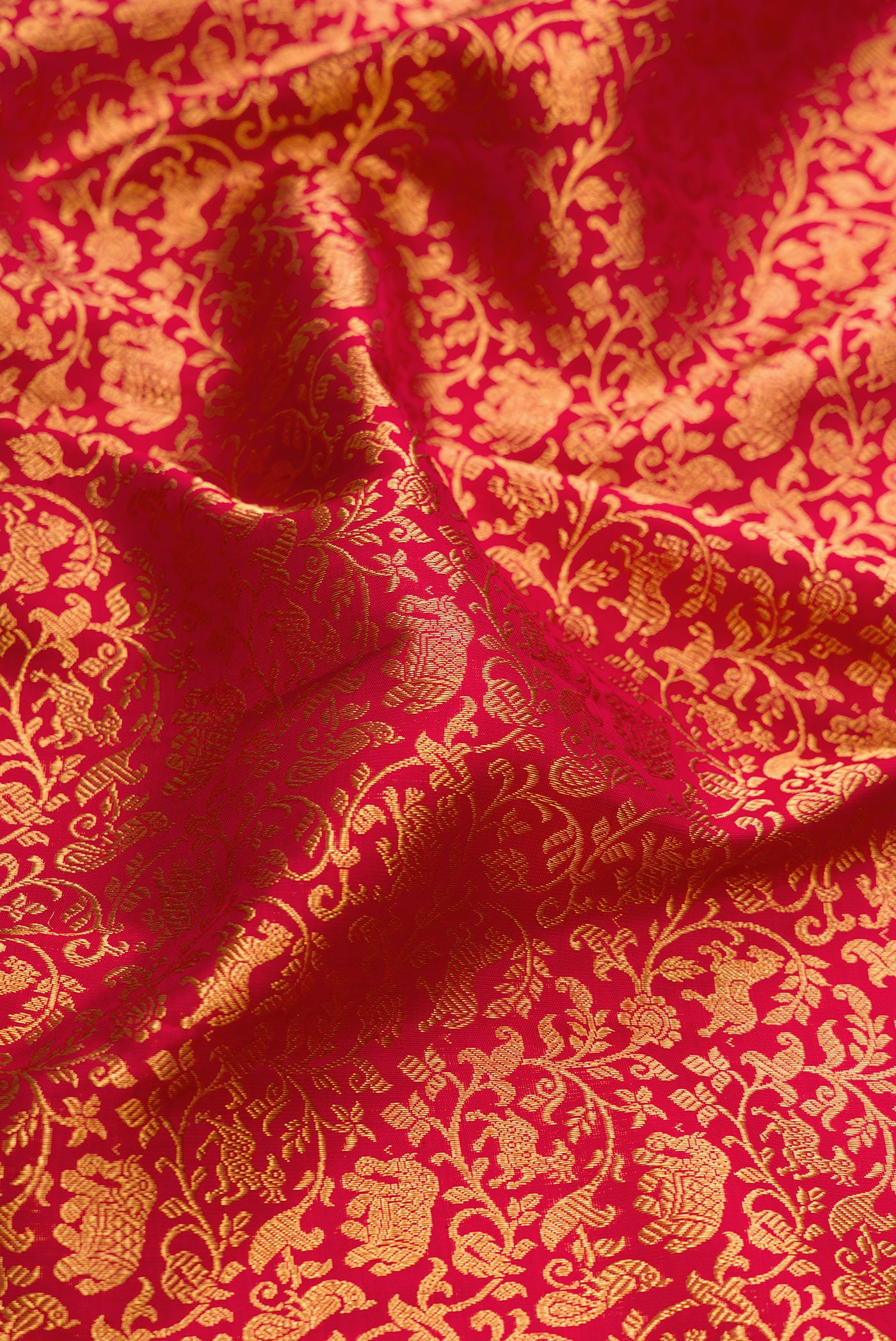 Close up of Maroon Dual Tone Kanchipuram Silk Saree with Zari Brocade on the body and Zari Border.  displaying folds