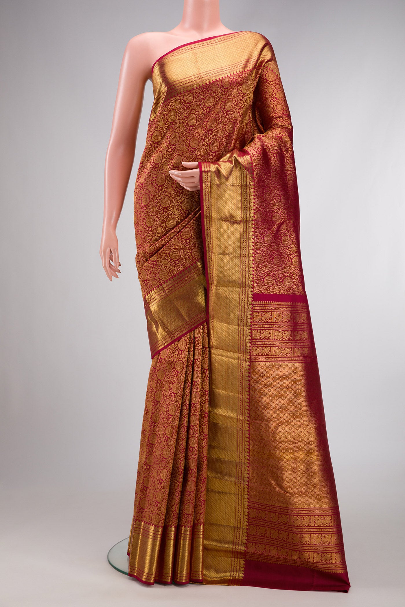Maroon Dual Tone Kanchipuram Silk Saree with Zari Brocade on the body and Zari Border.  displayed on a mannequin