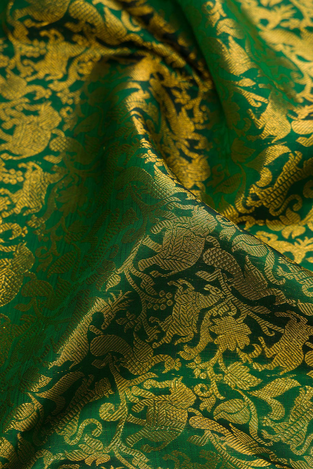 Close up of Green Dual Tone Kanchipuram Silk Saree with Zari Brocade on the body and Zari Border.  displaying folds