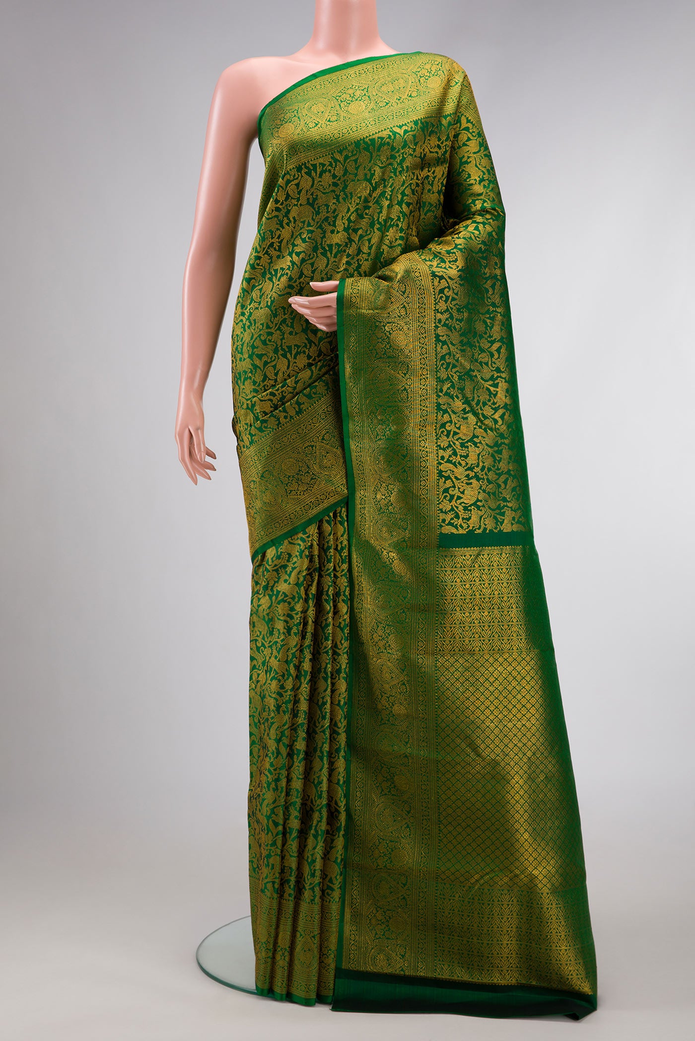 Green Dual Tone Kanchipuram Silk Saree with Zari Brocade on the body and Zari Border.  displayed on a mannequin