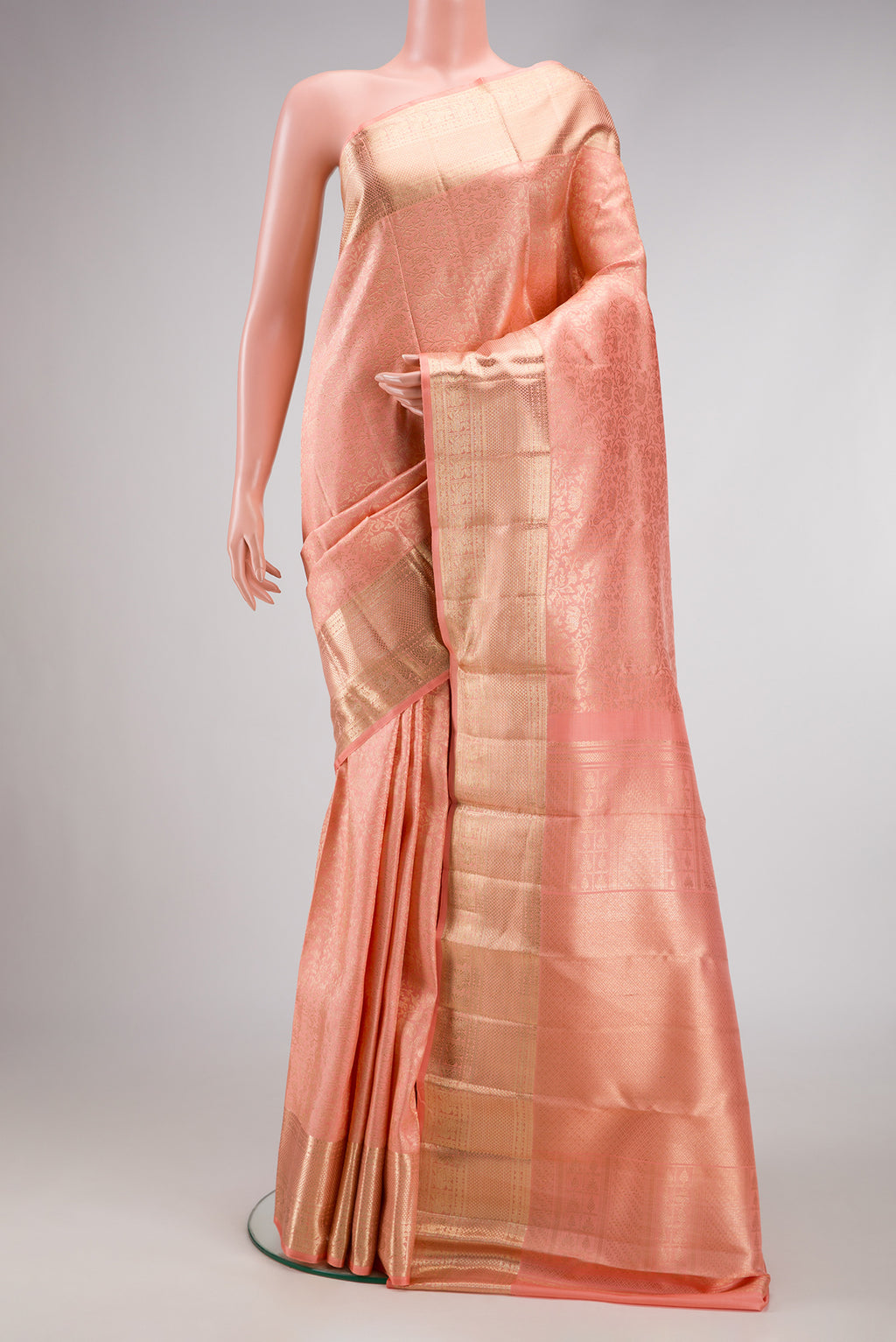Peach Dual Tone Kanchipuram Silk Saree with Zari Brocade on the body and Zari Border.  displayed on a mannequin