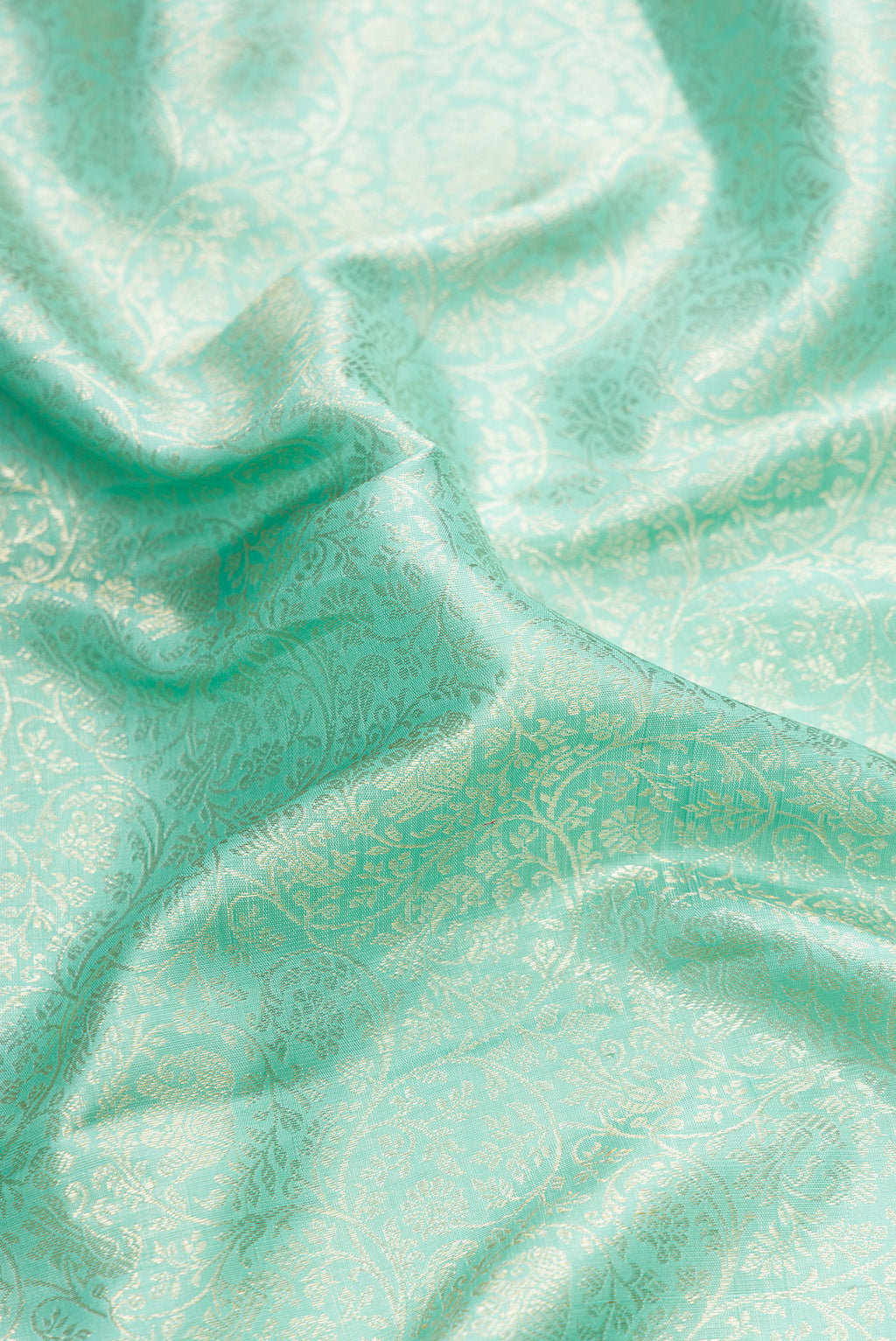 Close up of Light Blue Dual Tone Kanchipuram Silk Saree with Zari Brocade on the body and Zari Border.  displaying folds