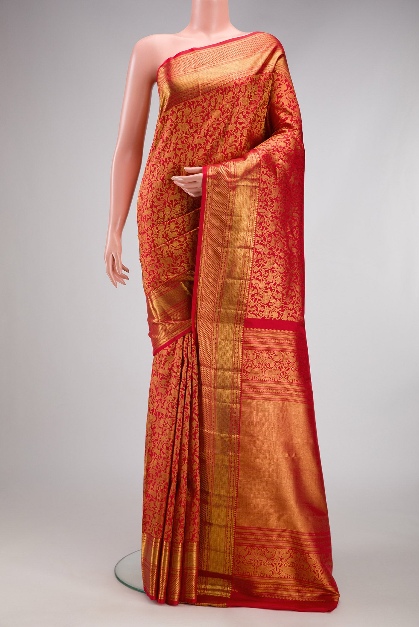 Red Kanchipuram Silk Saree with Zari Brocade on the body and Zari Border.  displayed on a mannequin
