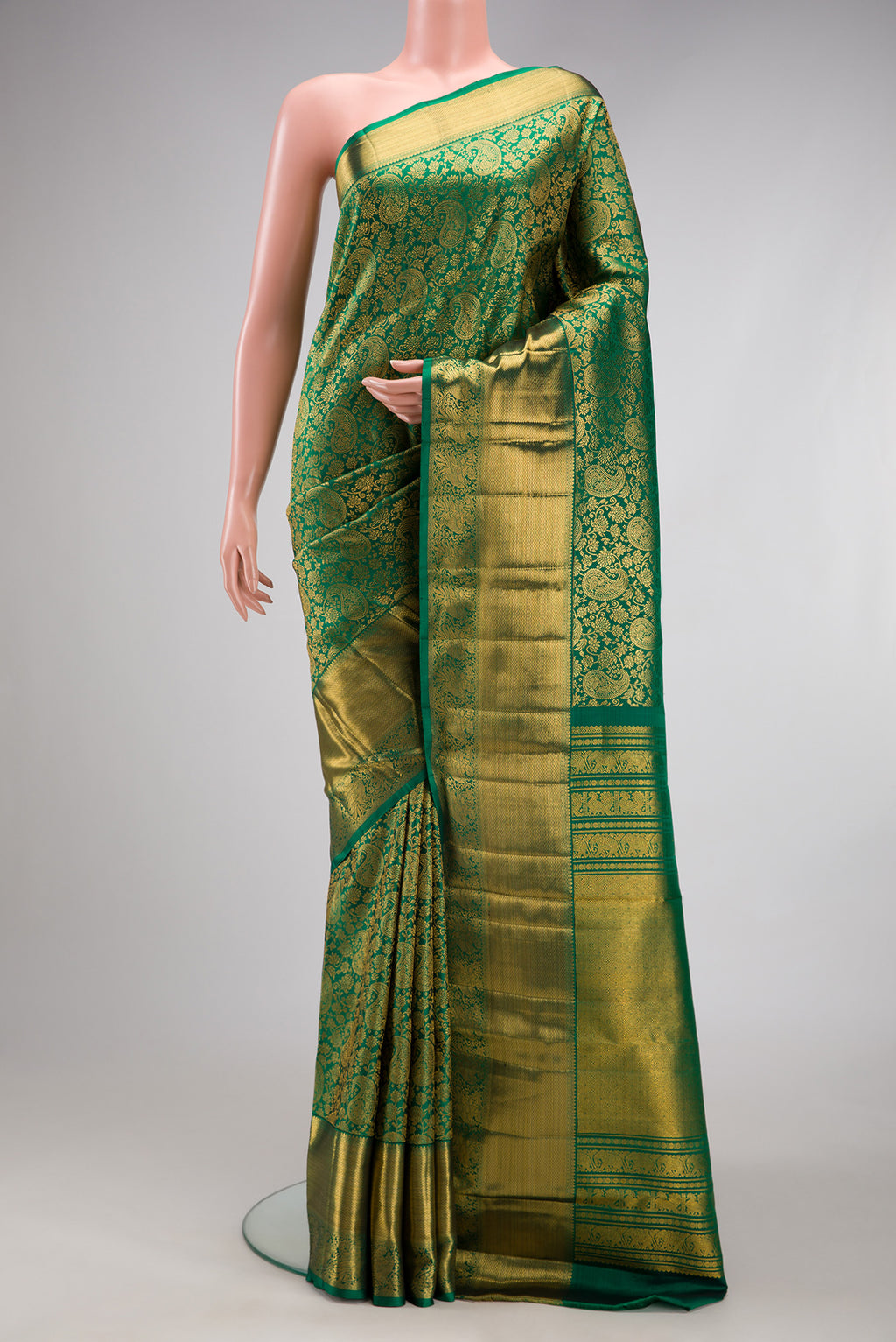 Bottle Green Kanchipuram Silk Saree with Zari Brocade on the body and Zari Border.  displayed on a mannequin