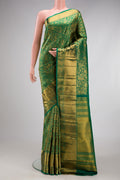 Bottle Green Kanchipuram Silk Saree with Zari Brocade on the body and Zari Border.  displayed on a mannequin
