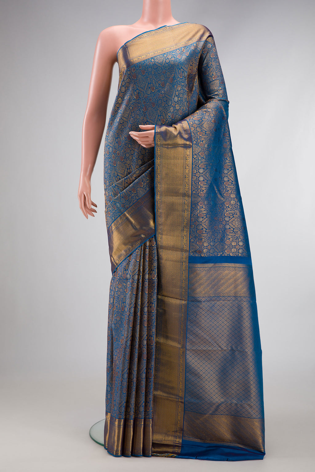 Peacock Blue Dual Tone Kanchipuram Silk Saree with Zari Brocade on the body and Zari Border.  displayed on a mannequin