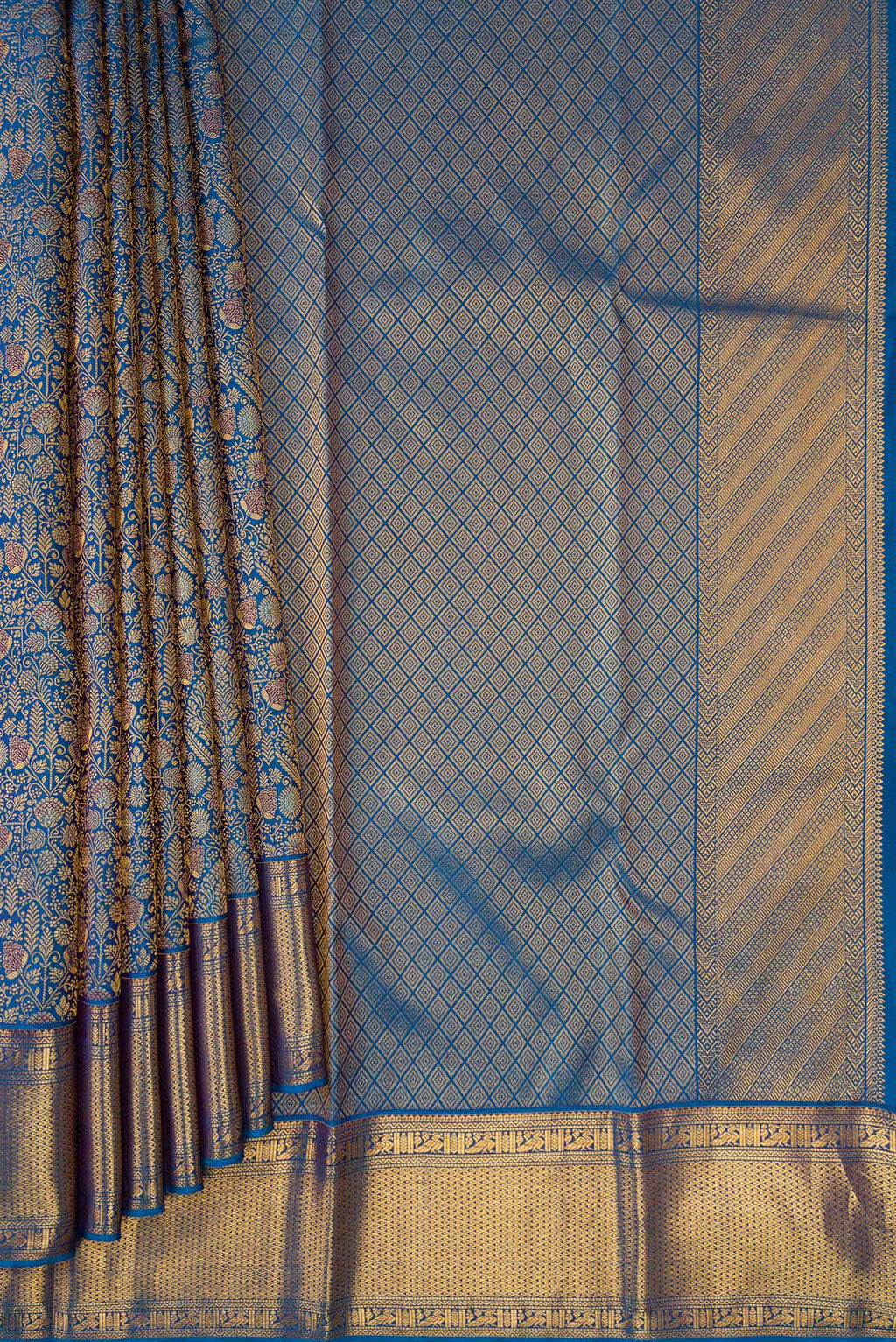 Pleats and pallu of Peacock Blue Dual Tone Kanchipuram Silk Saree with Zari Brocade on the body and Zari Border. 
