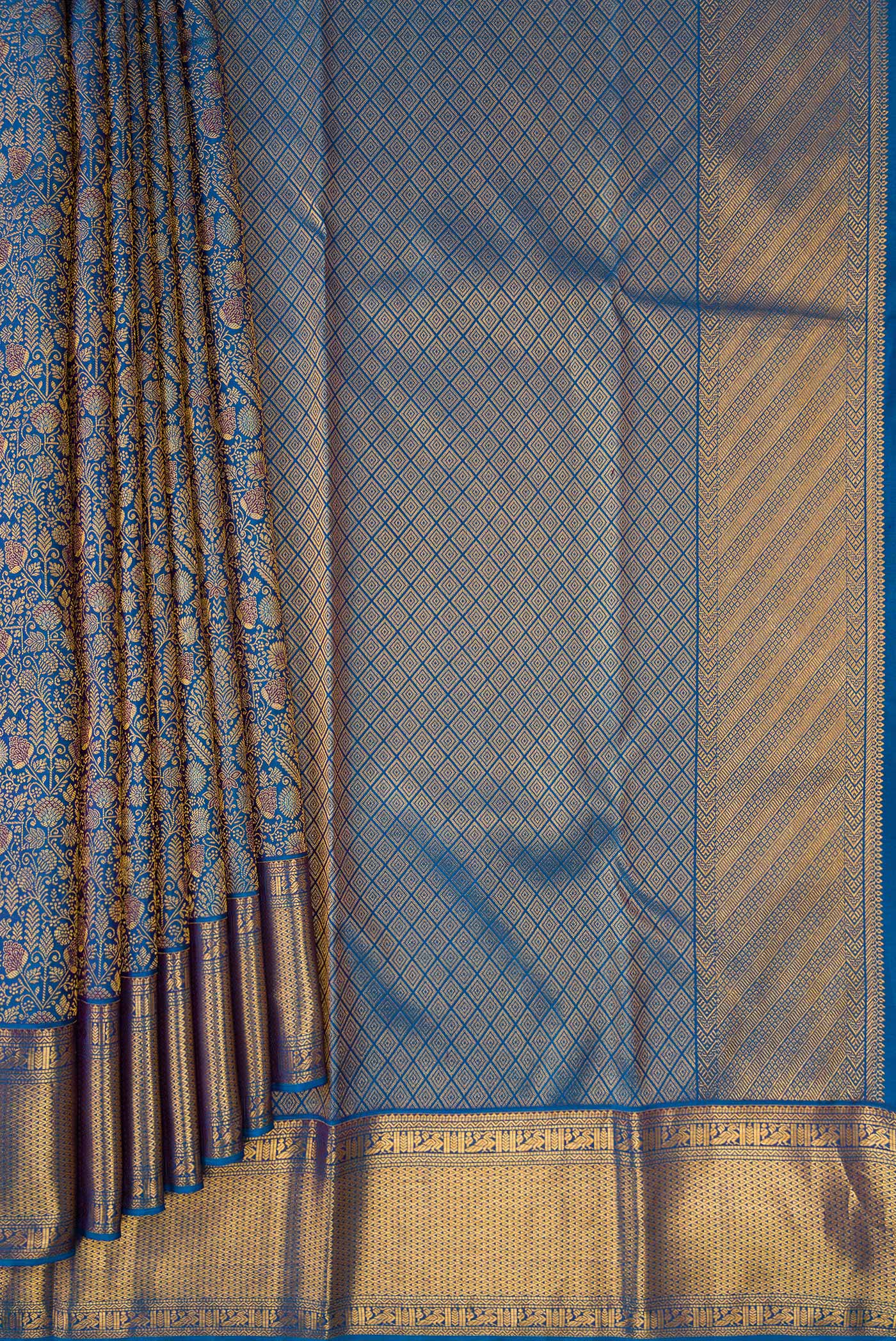 Pleats and pallu of Peacock Blue Dual Tone Kanchipuram Silk Saree with Zari Brocade on the body and Zari Border. 