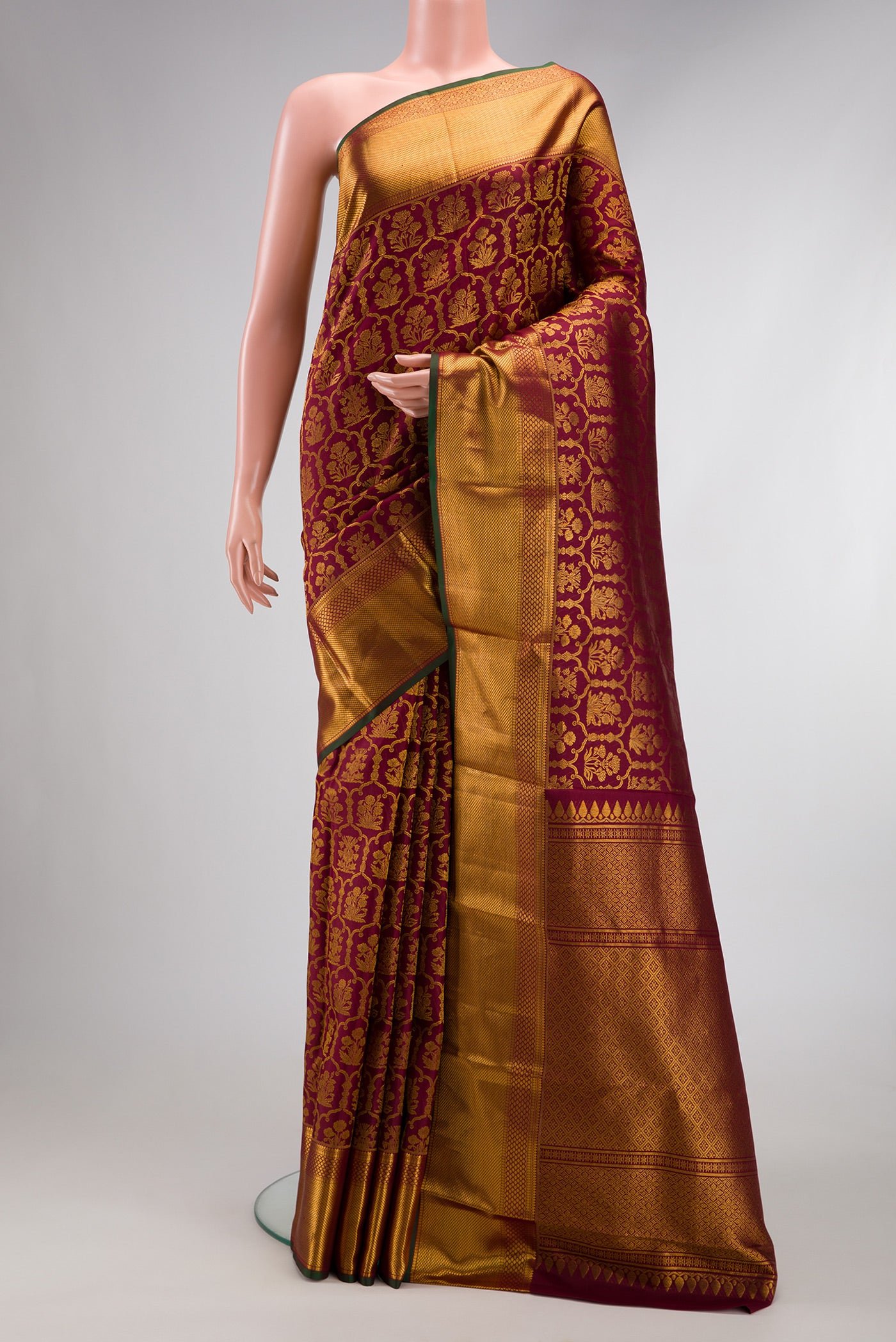 Maroon Dual Tone Kanchipuram Silk Saree with Zari Brocade on the body and Zari Border.  displayed on a mannequin