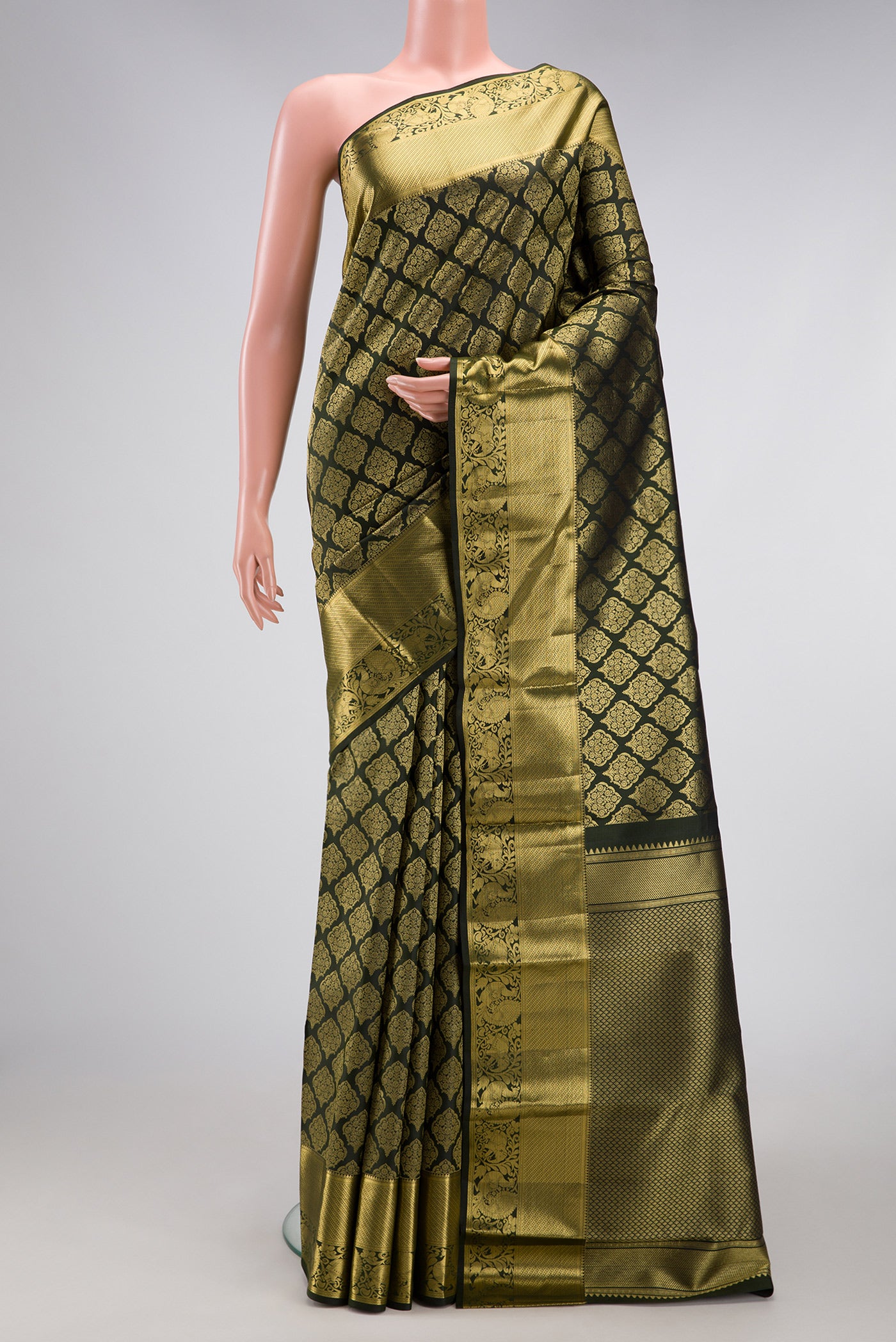 Bottle Green Kanchipuram Silk Saree with Zari Brocade on the body and Zari Border.  displayed on a mannequin