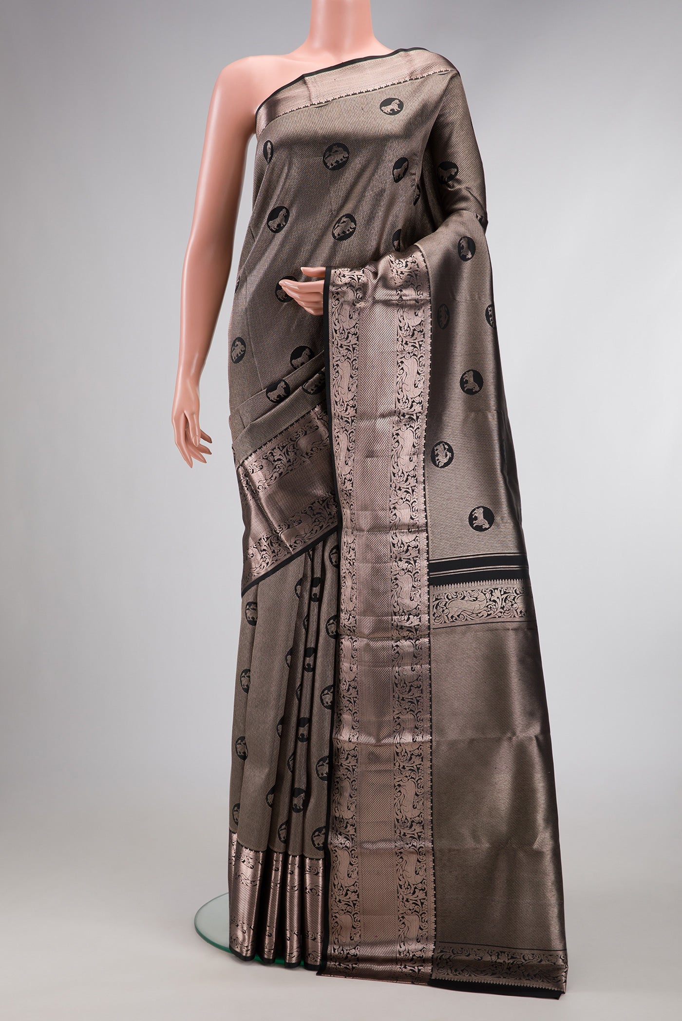 Black Dual Tone Kanchipuram Silk Saree with Zari Brocade on the body and Zari Border.  displayed on a mannequin