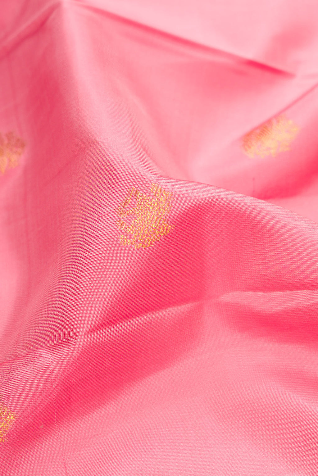 Close up of Pink Dual Tone Kanchipuram Silk Saree with Zari Butta on the body and Zari Border.  displaying folds