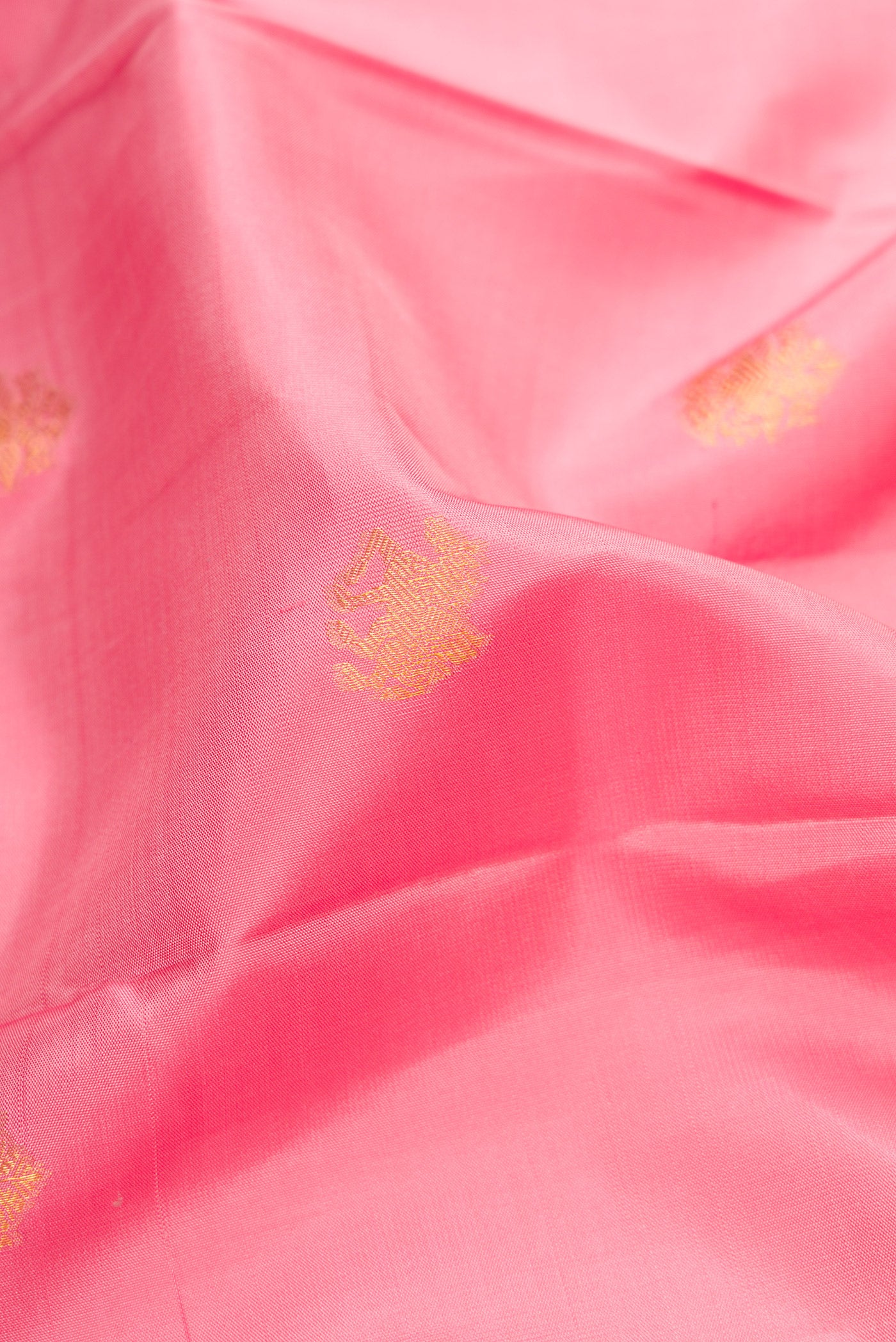 Close up of Pink Dual Tone Kanchipuram Silk Saree with Zari Butta on the body and Zari Border.  displaying folds