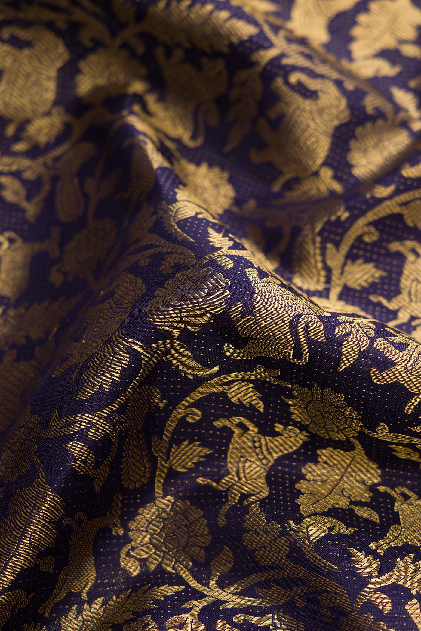 Close up of Navy Blue Dual Tone Kanchipuram Silk Saree with Zari Brocade on the body and Zari Border.  displaying folds