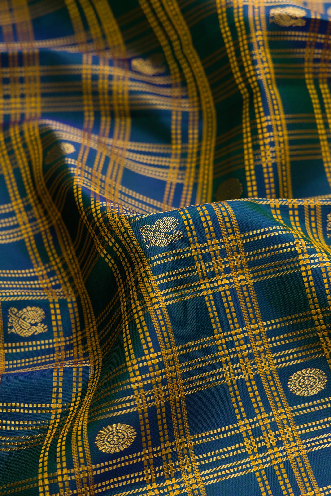 Close up of Pure Silk Pure Zari Navy Blue Dual Tone Kanjivaram Saree with Checked design on the body and Zari Border.  displaying folds