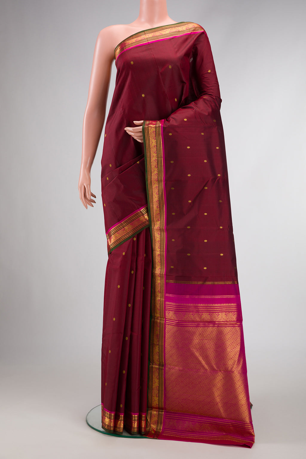 Maroon Dual Tone Kanjivaram Silk Saree with Zari Butta on the body and Zari Border.  displayed on a mannequin