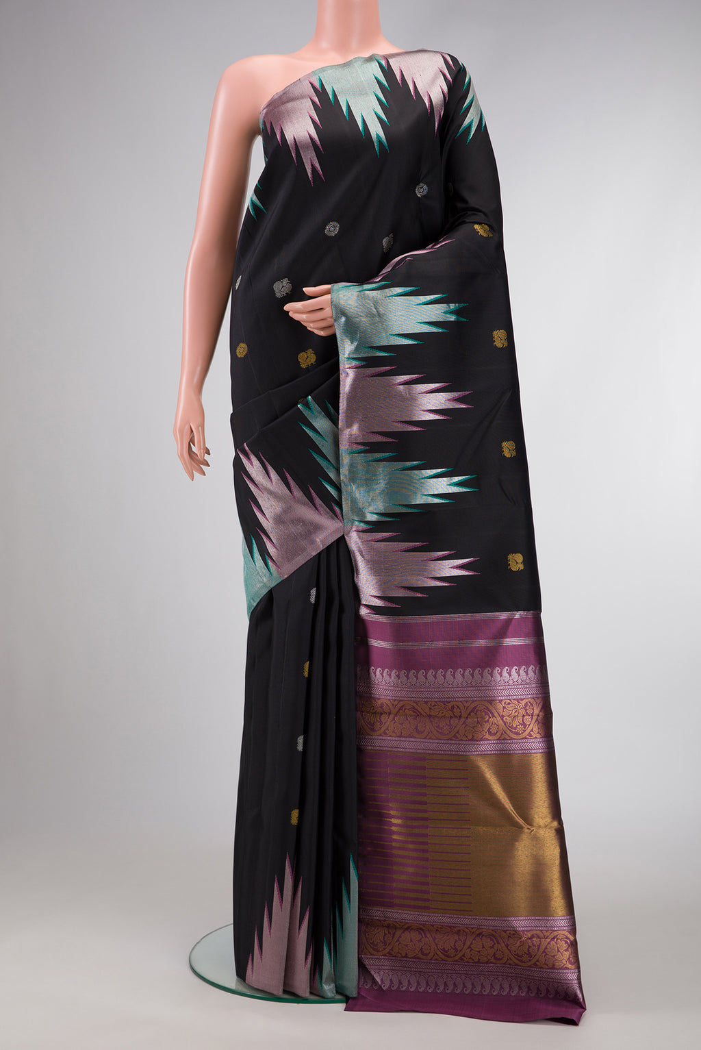 Black Dual Tone Kanchipuram Silk Saree with Zari Butta on the body and Temple Border.  displayed on a mannequin