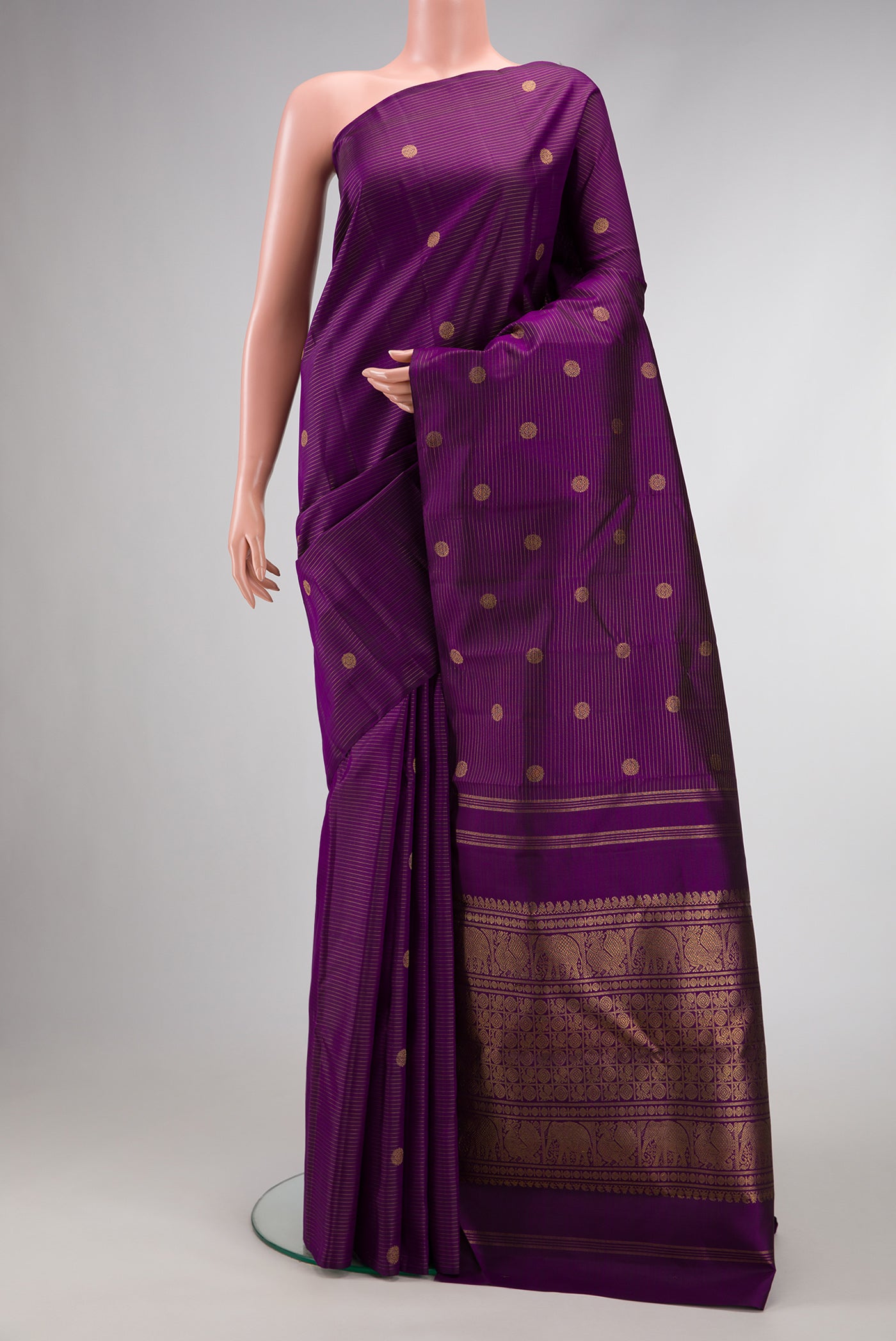 Pure Silk Pure Zari Purple Dual Tone Kanchipuram Saree with Zari Butta on the body and Without Border.  displayed on a mannequin