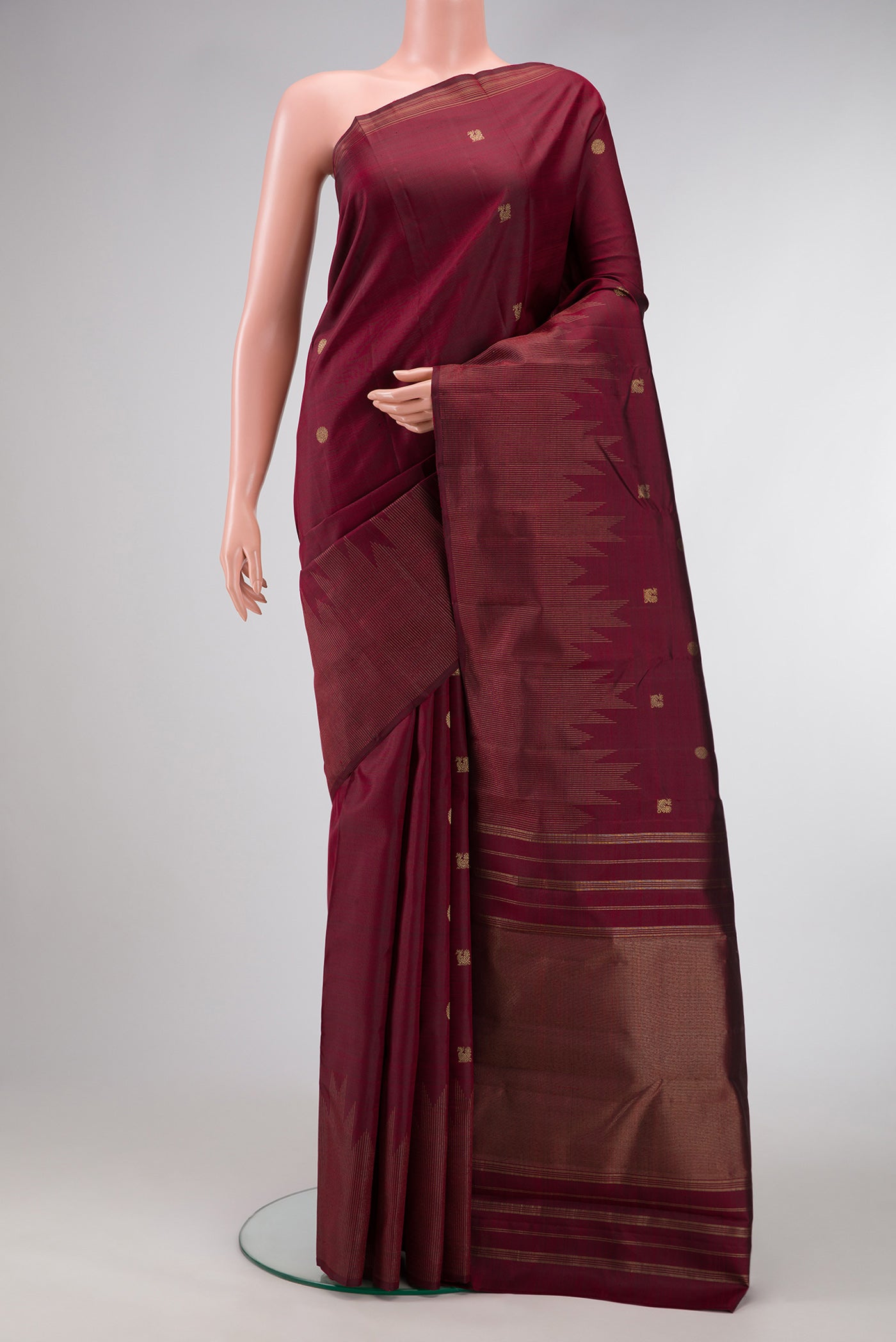 Pure Silk Pure Zari Maroon Dual Tone Kanchipuram Saree with Zari Butta on the body and Zari Border.  displayed on a mannequin