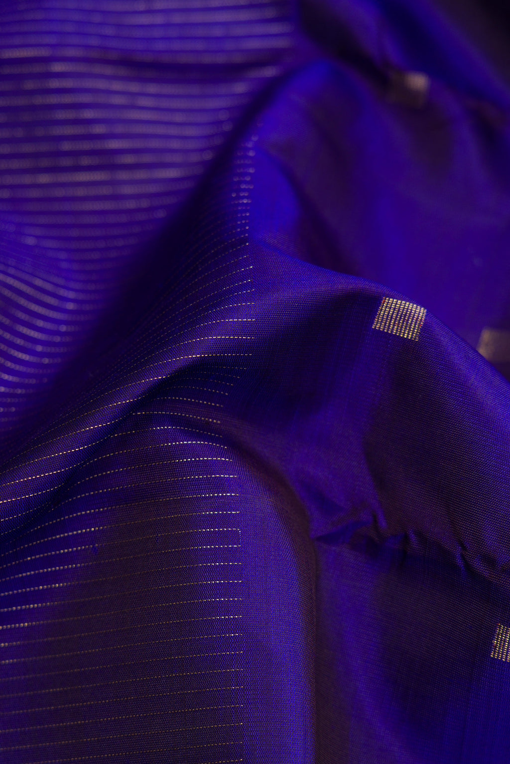 Close up of Pure Silk Pure Zari Royal Blue Dual Tone Kanchipuram Saree with Half And Half on the body and Without Border.  displaying folds