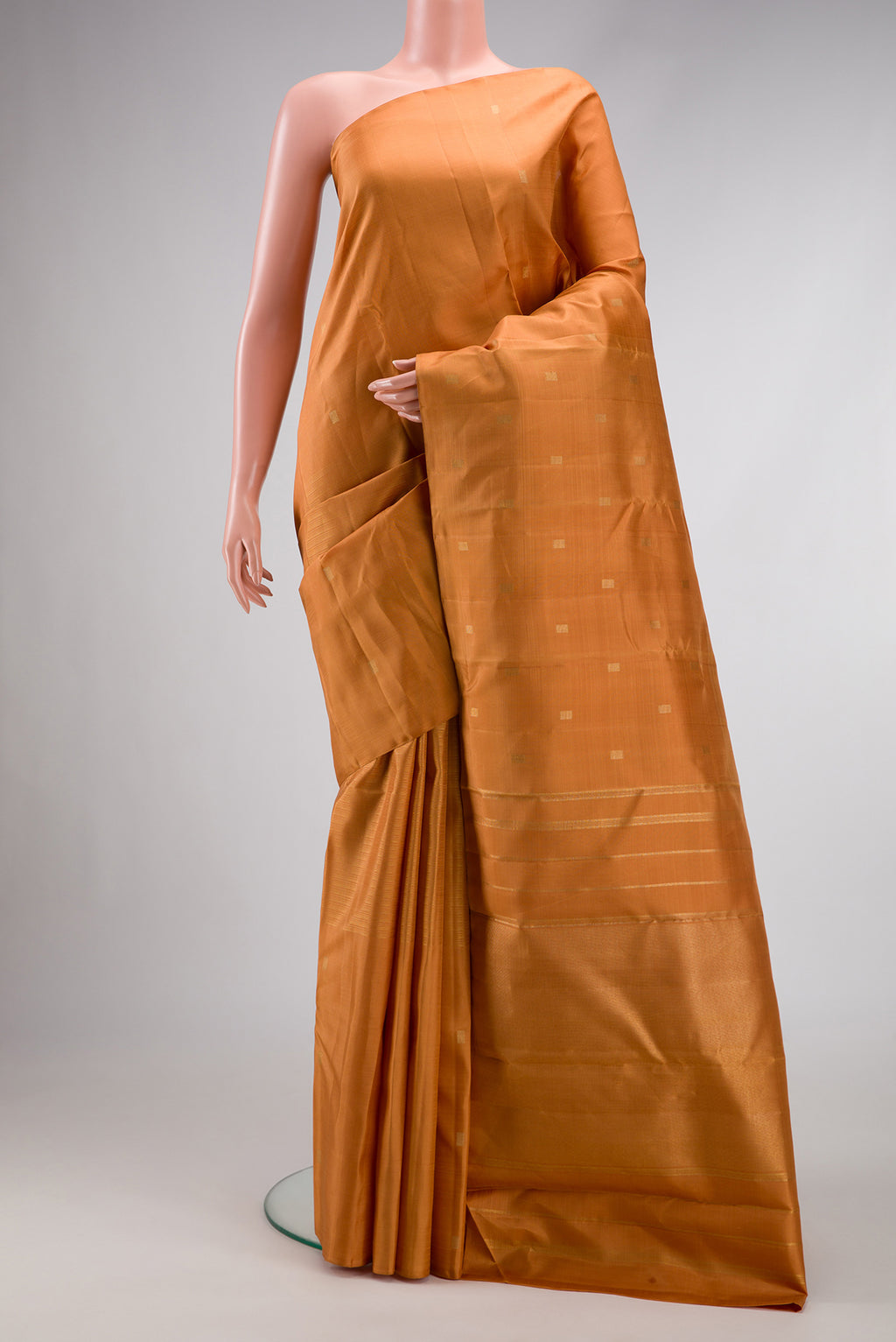 Pure Silk Pure Zari Golden Dual Tone Kanchipuram Saree with Zari Butta on the body and Without Border.  displayed on a mannequin