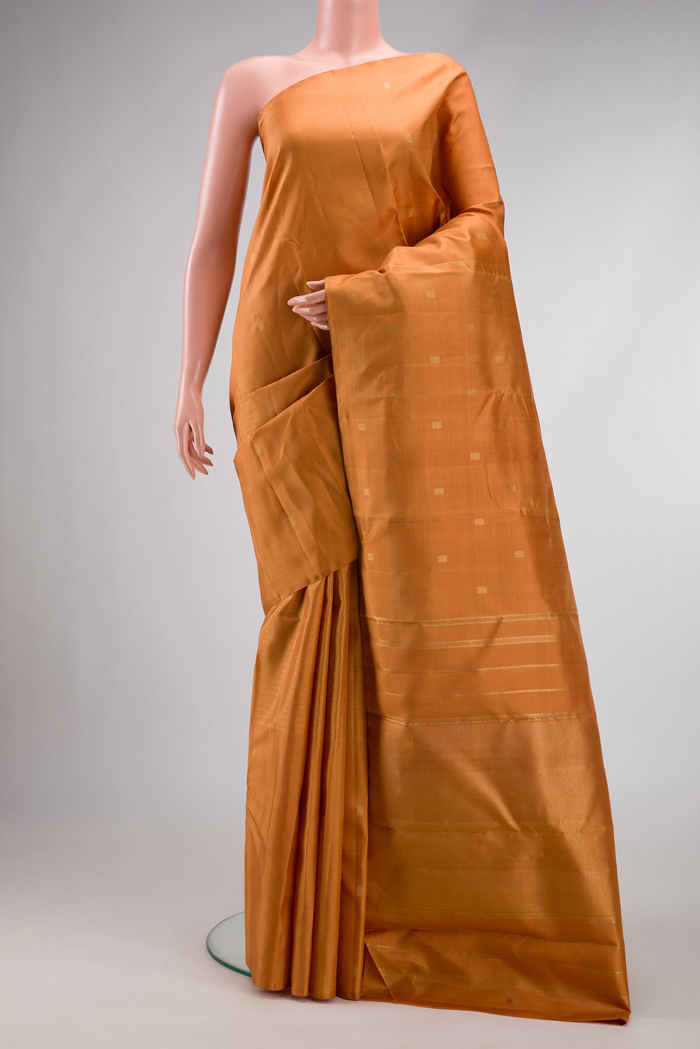 Pure Silk Pure Zari Golden Dual Tone Kanchipuram Saree with Zari Butta on the body and Without Border.  displayed on a mannequin