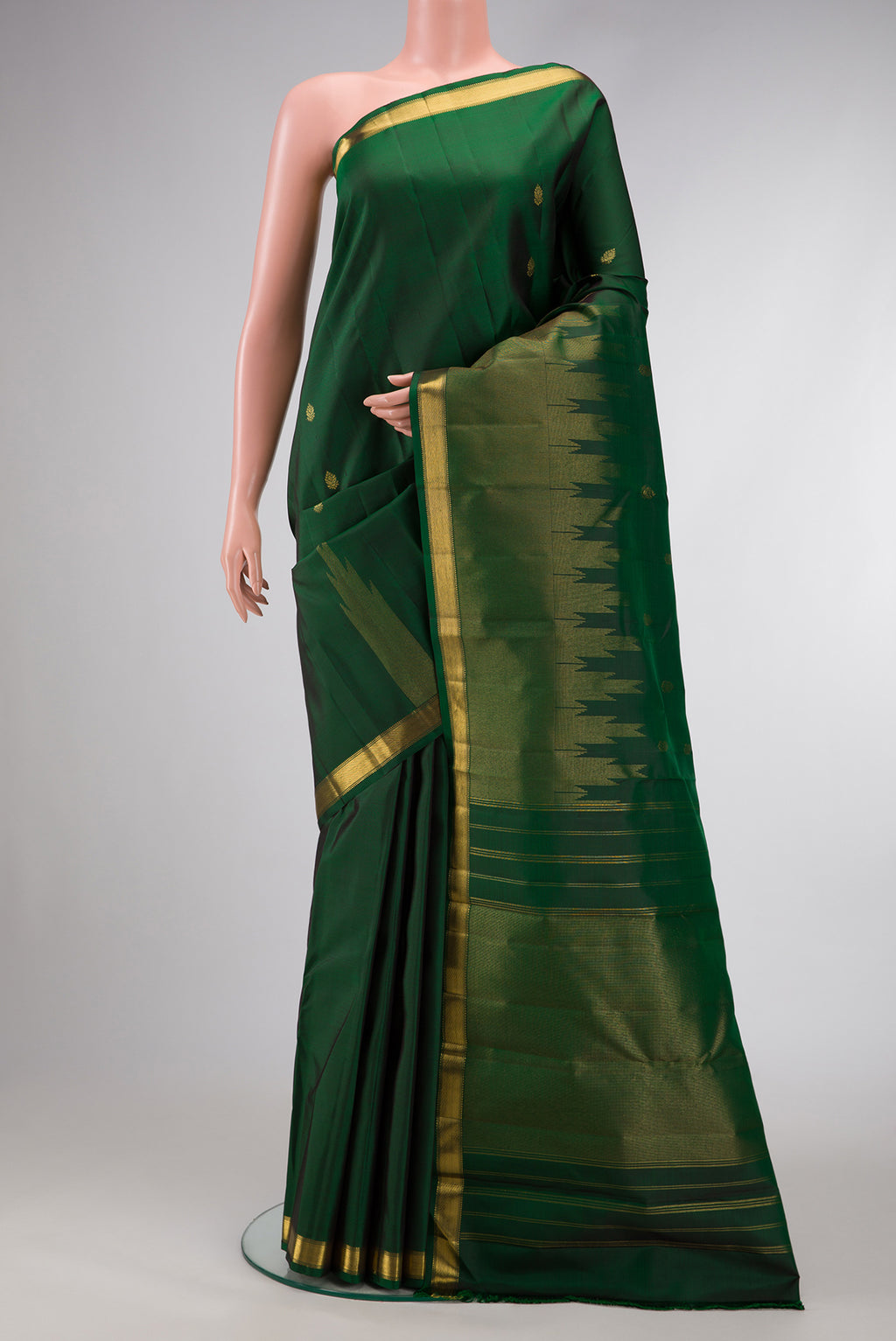 Green Dual Tone Kanchipuram Silk Saree with Zari Butta on the body and Zari Border.  displayed on a mannequin