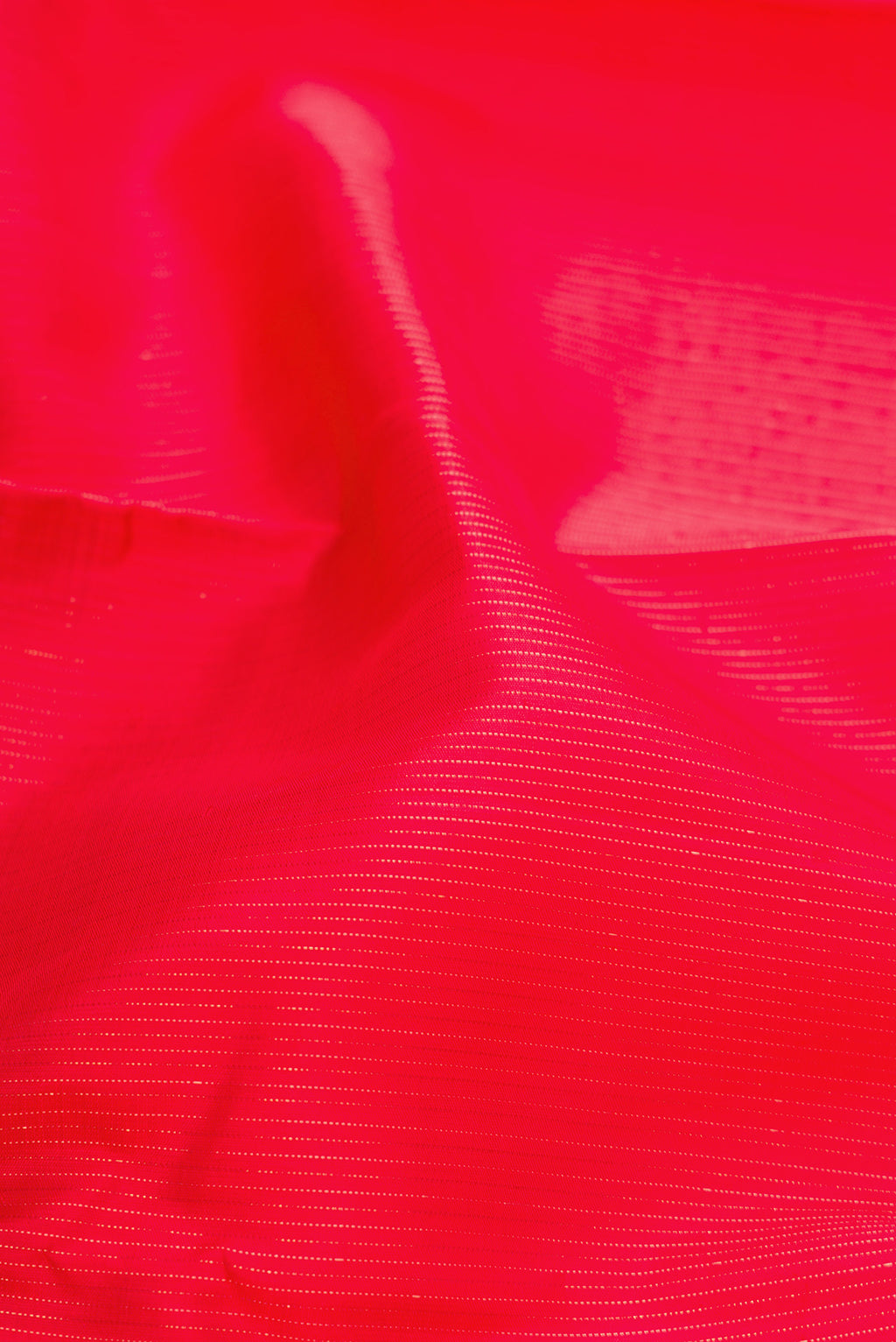 Close up of Red Dual Tone Kanjivaram Silk Saree with Stripes on the body and Without Border.  displaying folds