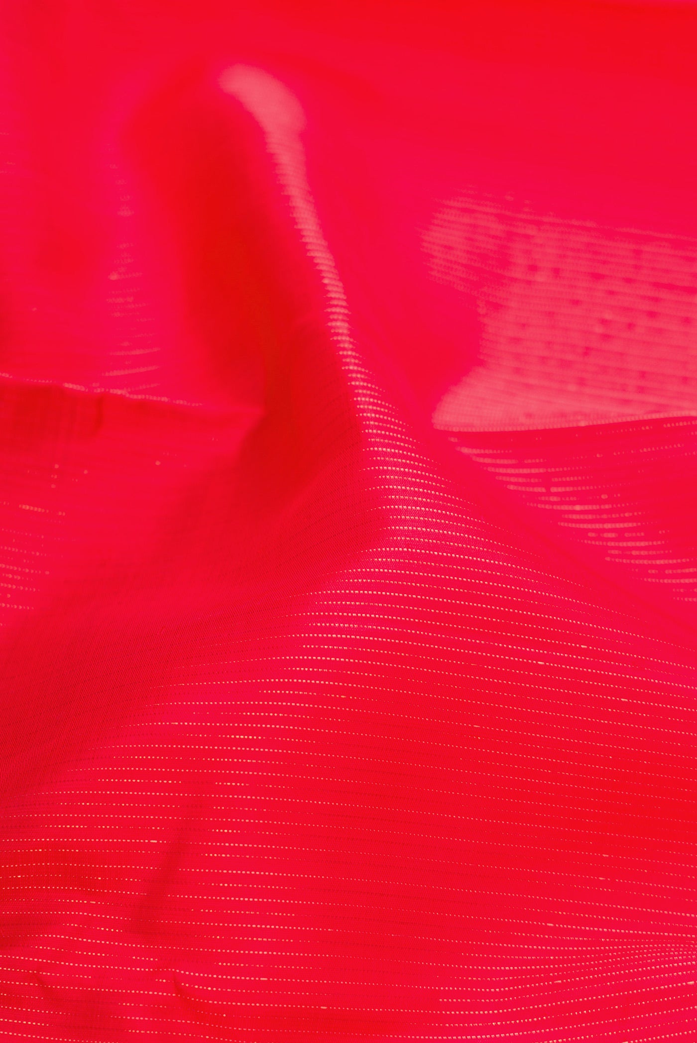 Close up of Red Dual Tone Kanjivaram Silk Saree with Stripes on the body and Without Border.  displaying folds