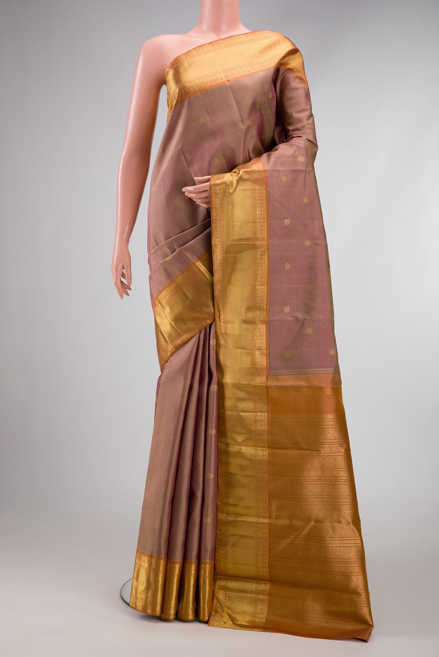 Pure Silk Pure Zari Rose Gold Kanjivaram Saree with Zari Butta on the body and Zari Border.  displayed on a mannequin
