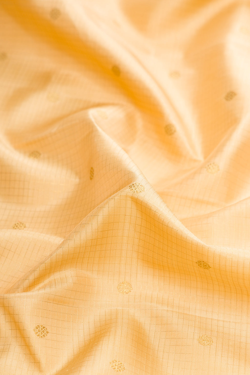 Close up of Pure Silk Pure Zari Sandal Dual Tone Kanjivaram Saree with Zari Butta on the body and Zari Border.  displaying folds