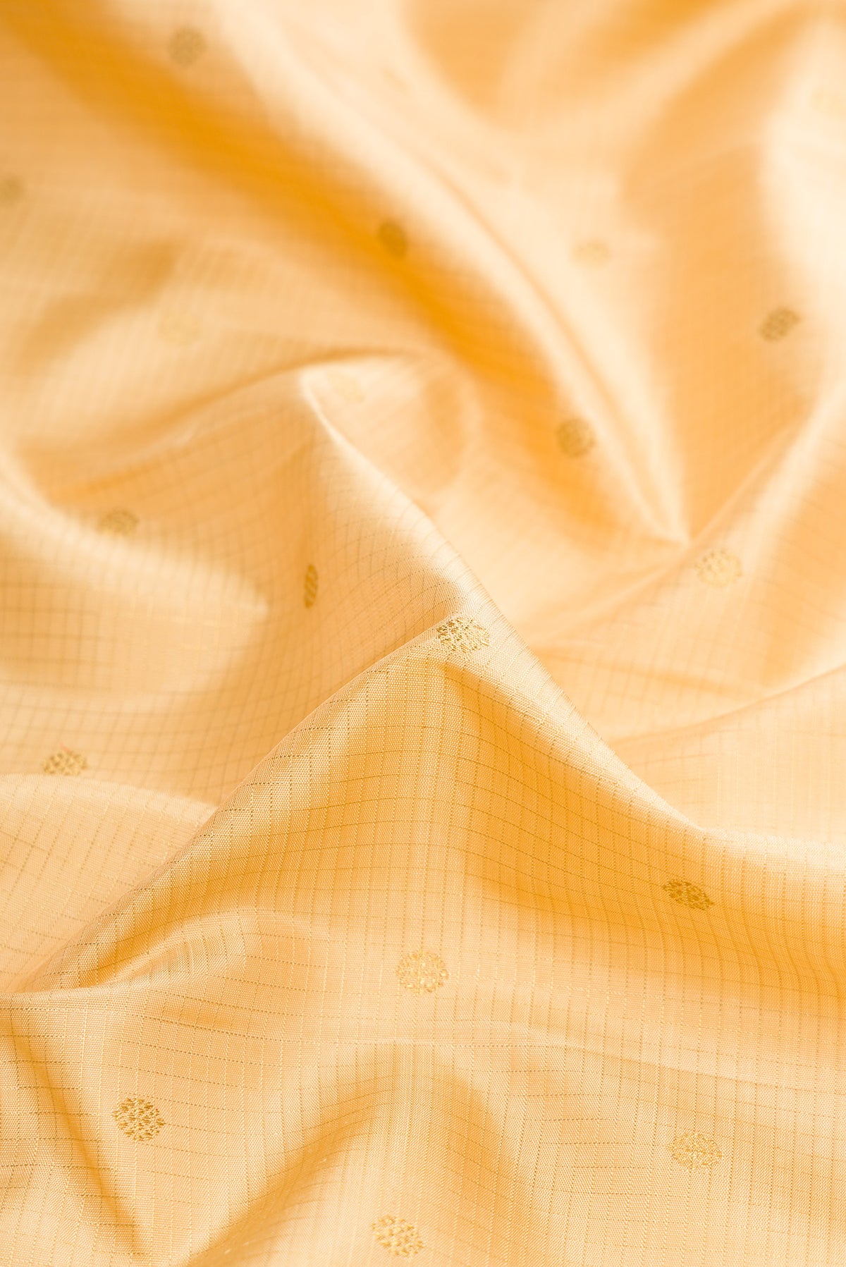 Close up of Pure Silk Pure Zari Sandal Dual Tone Kanjivaram Saree with Zari Butta on the body and Zari Border.  displaying folds
