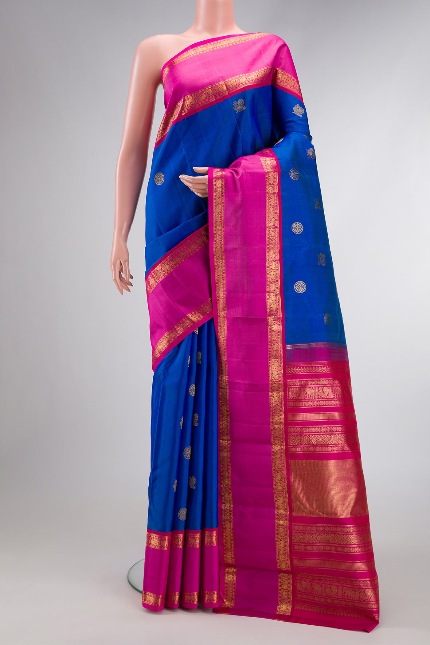 Pure Silk Pure Zari Royal Blue Dual Tone Kanjivaram Saree with Zari Butta on the body and Zari Border.  displayed on a mannequin