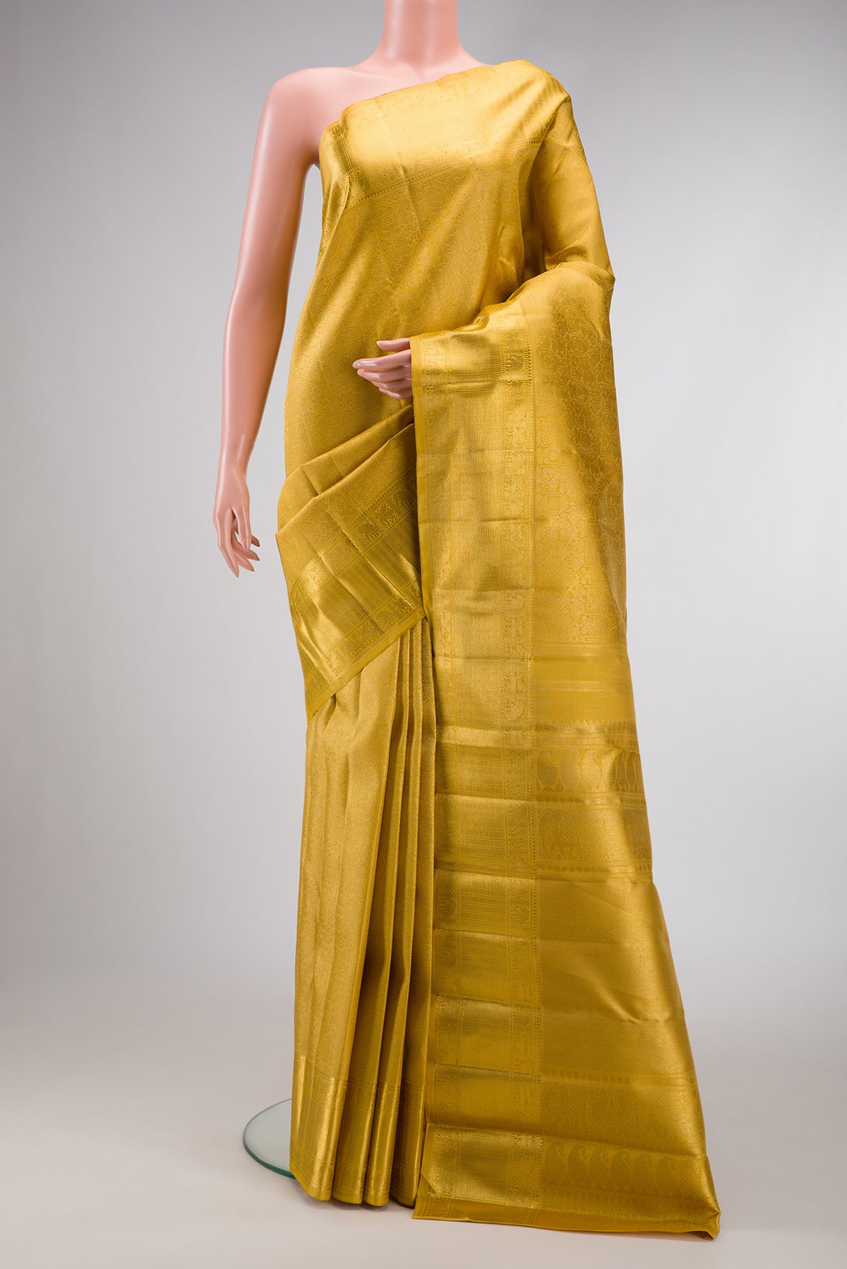 Pure Silk Pure Zari Mustard Dual Tone Kanjivaram Saree with Zari Brocade on the body and Zari Border.  displayed on a mannequin