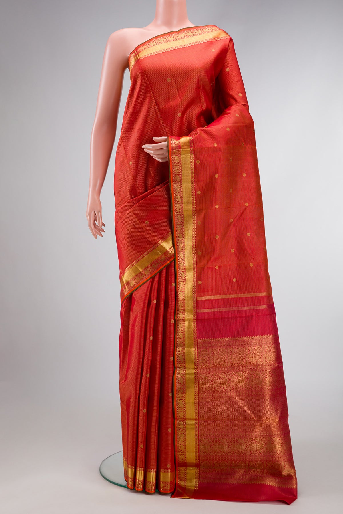 Pure Silk Pure Zari Brick Orange Dual Tone Kanjivaram Saree with Stripes on the body and Zari Border.  displayed on a mannequin