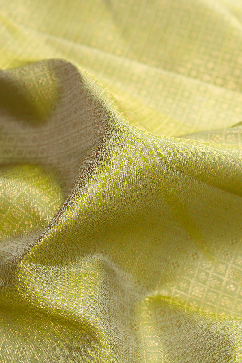 Close up of Pure Silk Pure Zari Green Dual Tone Kanjivaram Saree with Zari Brocade on the body and Zari Border.  displaying folds