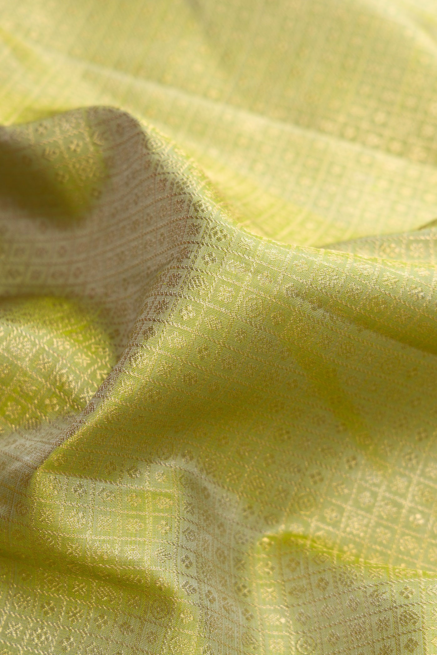 Close up of Pure Silk Pure Zari Green Dual Tone Kanjivaram Saree with Zari Brocade on the body and Zari Border.  displaying folds