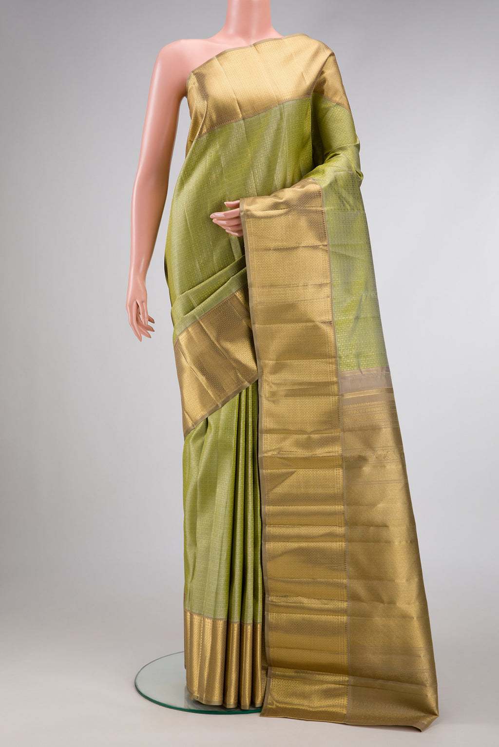 Pure Silk Pure Zari Green Dual Tone Kanjivaram Saree with Zari Brocade on the body and Zari Border.  displayed on a mannequin