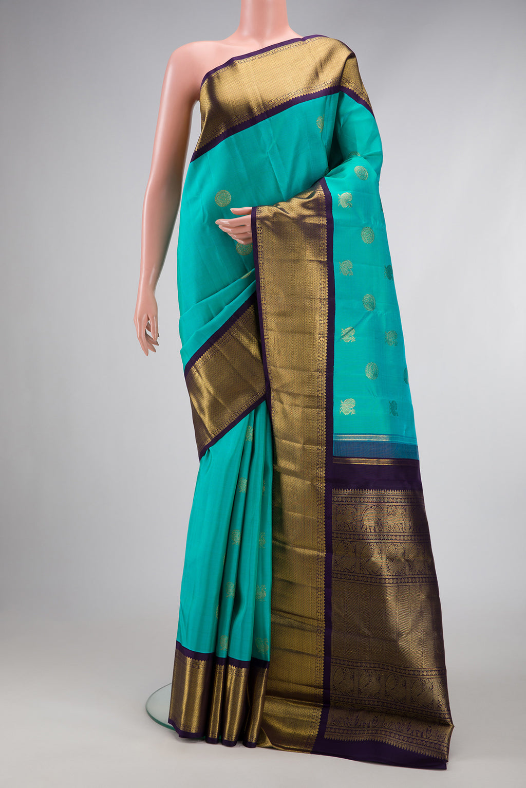 Pure Silk Pure Zari Sky Blue Dual Tone Kanjivaram Saree with Zari Butta on the body and Zari Border.  displayed on a mannequin