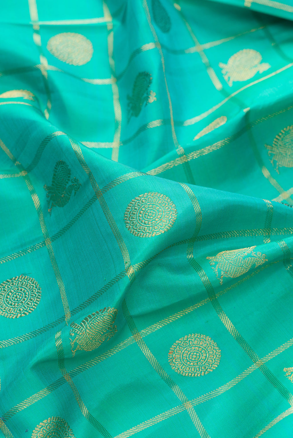 Close up of Pure Silk Pure Zari Sea Green Kanjivaram Saree with Checked design on the body and Zari Border.  displaying folds
