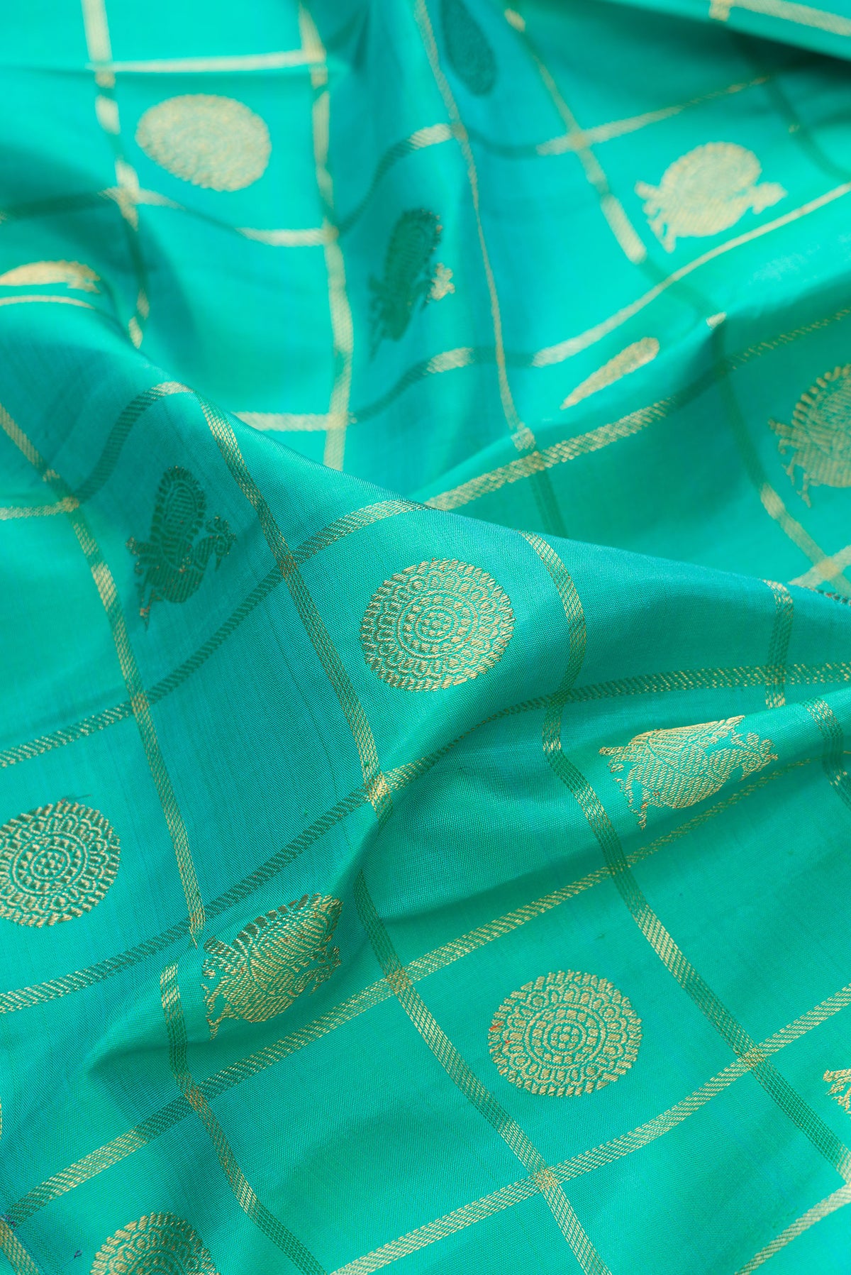 Close up of Pure Silk Pure Zari Sea Green Kanjivaram Saree with Checked design on the body and Zari Border.  displaying folds