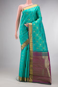 Pure Silk Pure Zari Sea Green Kanjivaram Saree with Checked design on the body and Zari Border.  displayed on a mannequin