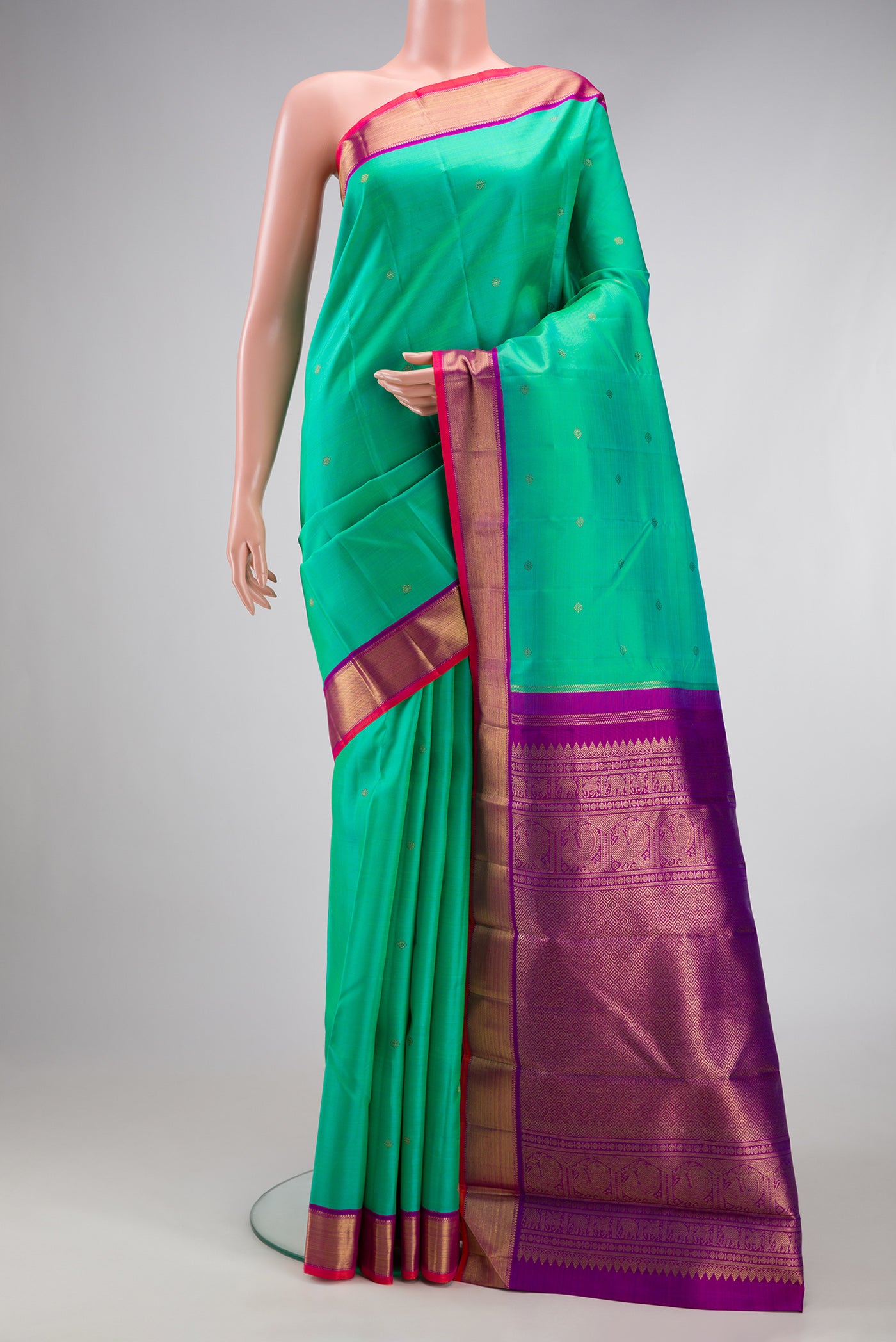 Pure Silk Pure Zari Sea Green Kanjivaram Saree with Zari Butta on the body and Zari Border.  displayed on a mannequin
