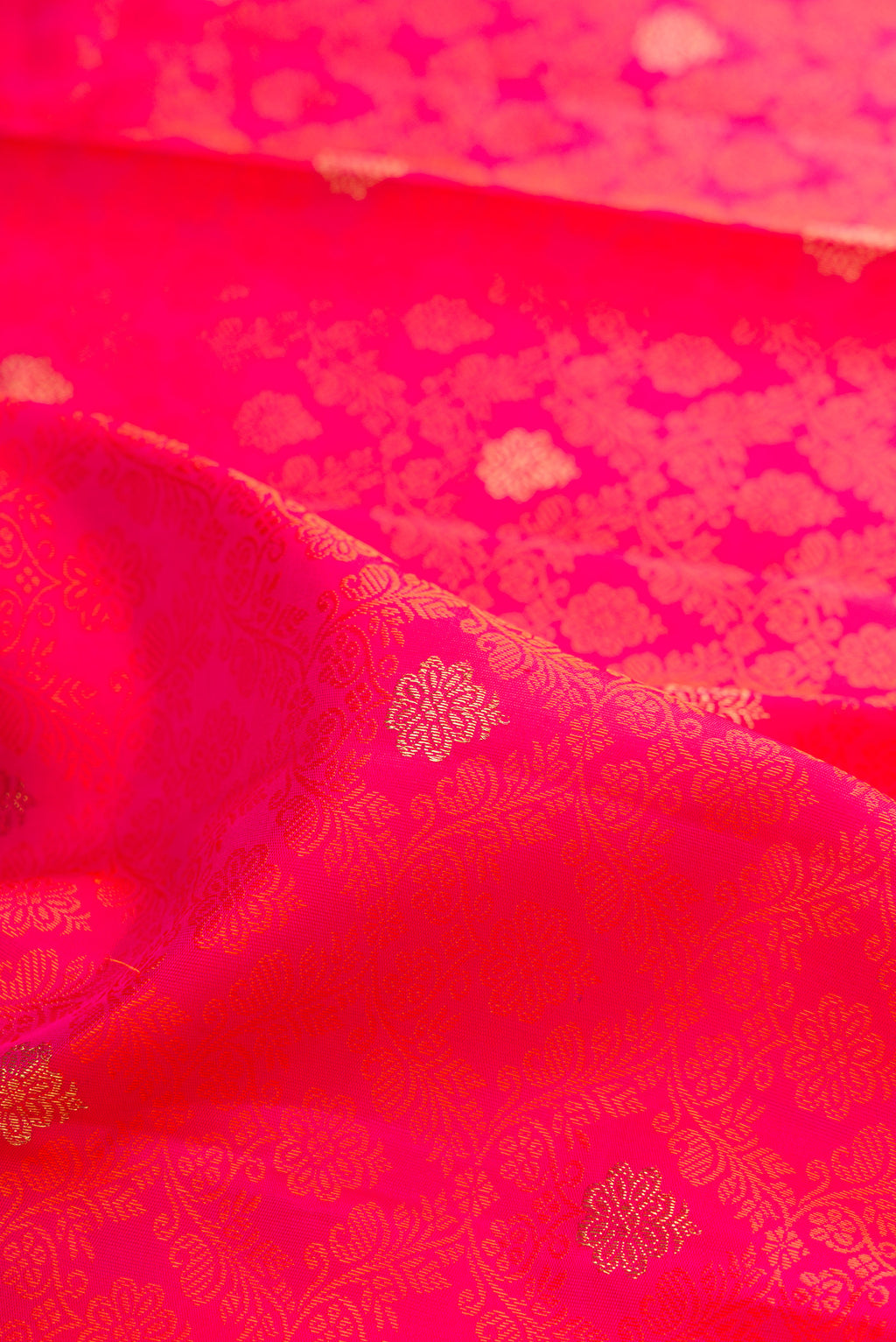 Close up of Pure Silk Pure Zari Pink Dual Tone Kanjivaram Saree with Jacquard With Zari Butta on the body and Zari Border.  displaying folds