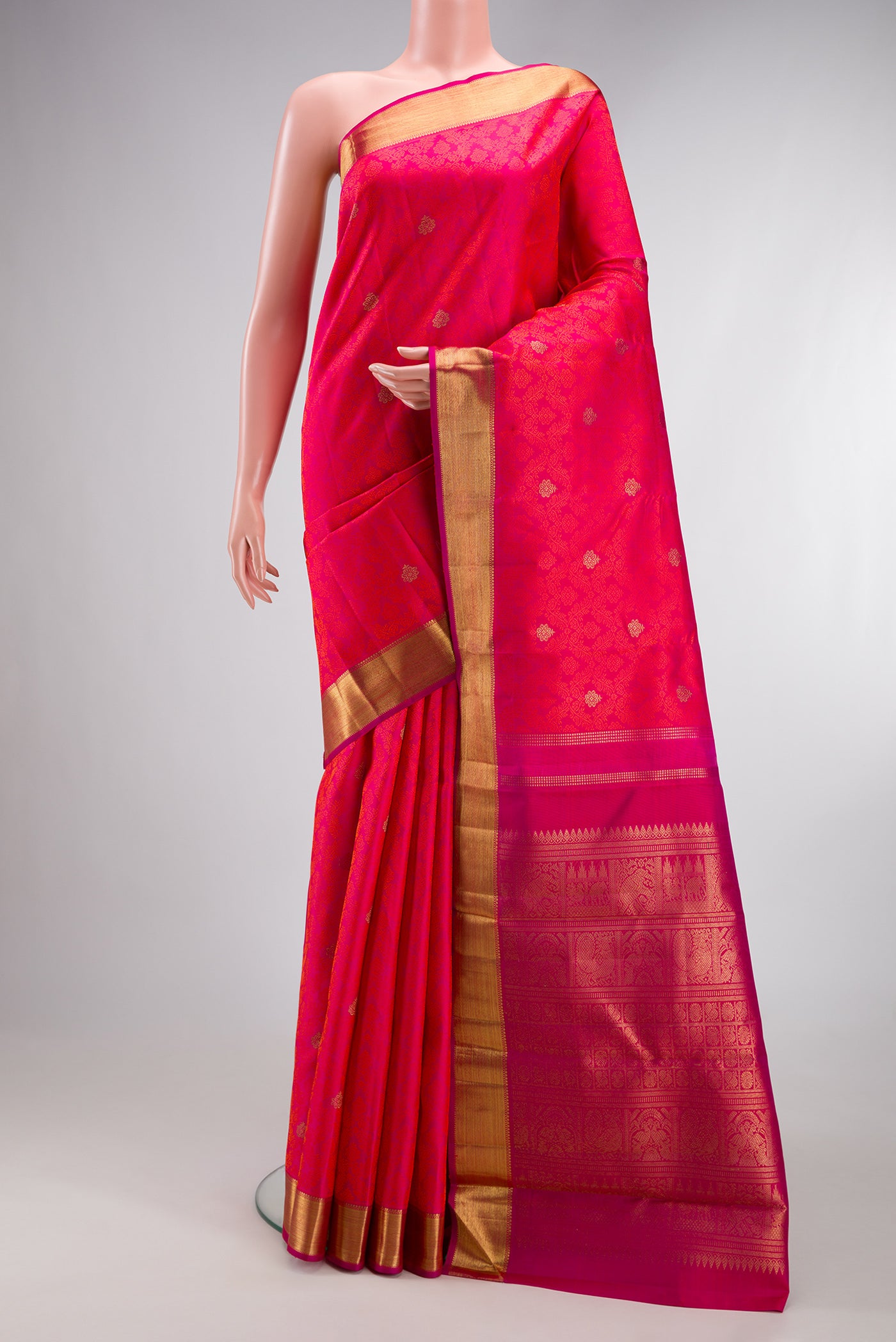 Pure Silk Pure Zari Pink Dual Tone Kanjivaram Saree with Jacquard With Zari Butta on the body and Zari Border.  displayed on a mannequin