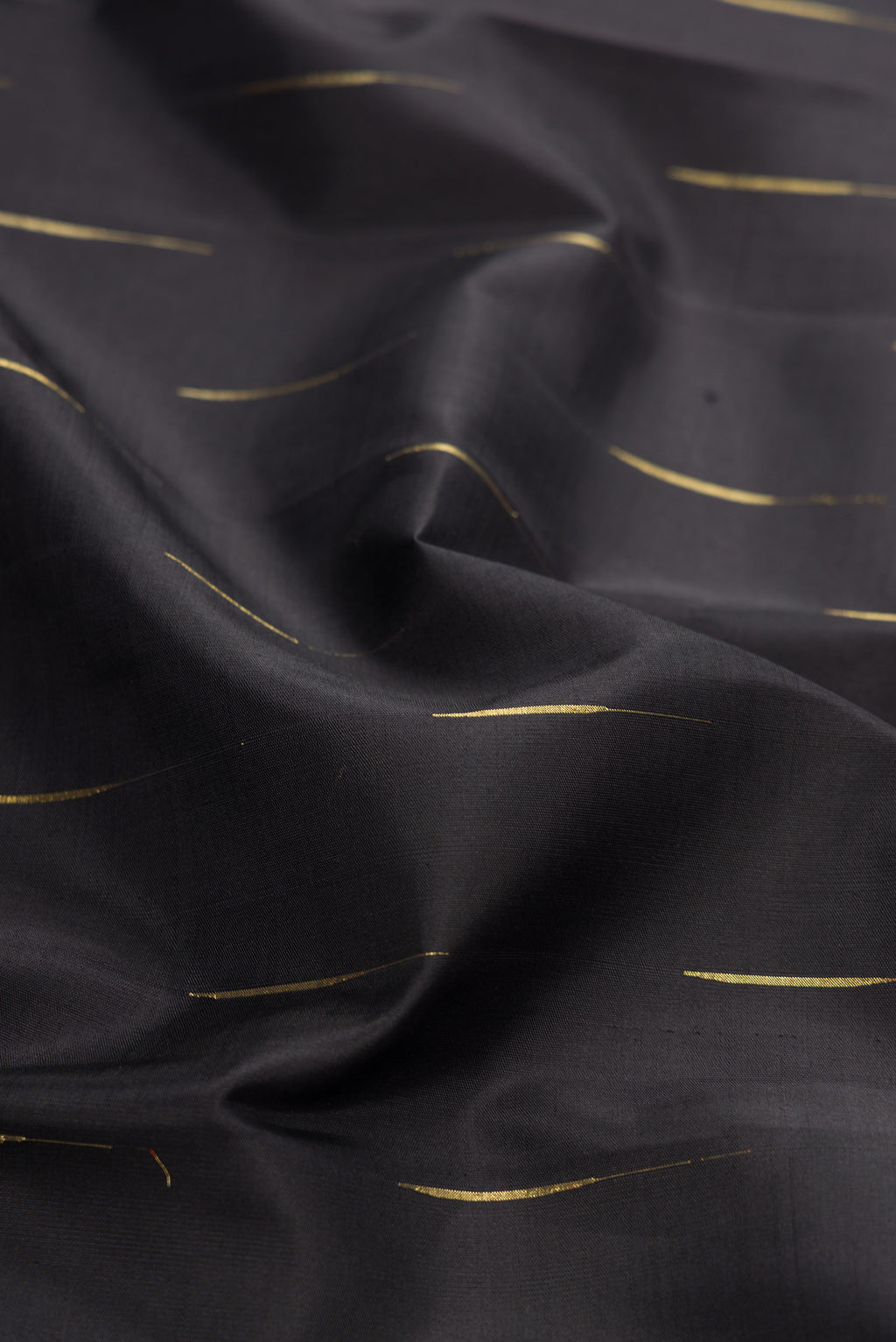 Close up of Black Dual Tone Kanjivaram Silk Saree with Zari Butta on the body and Zari Border.  displaying folds