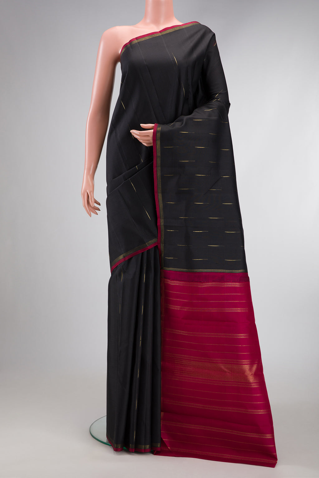 Black Dual Tone Kanjivaram Silk Saree with Zari Butta on the body and Zari Border.  displayed on a mannequin